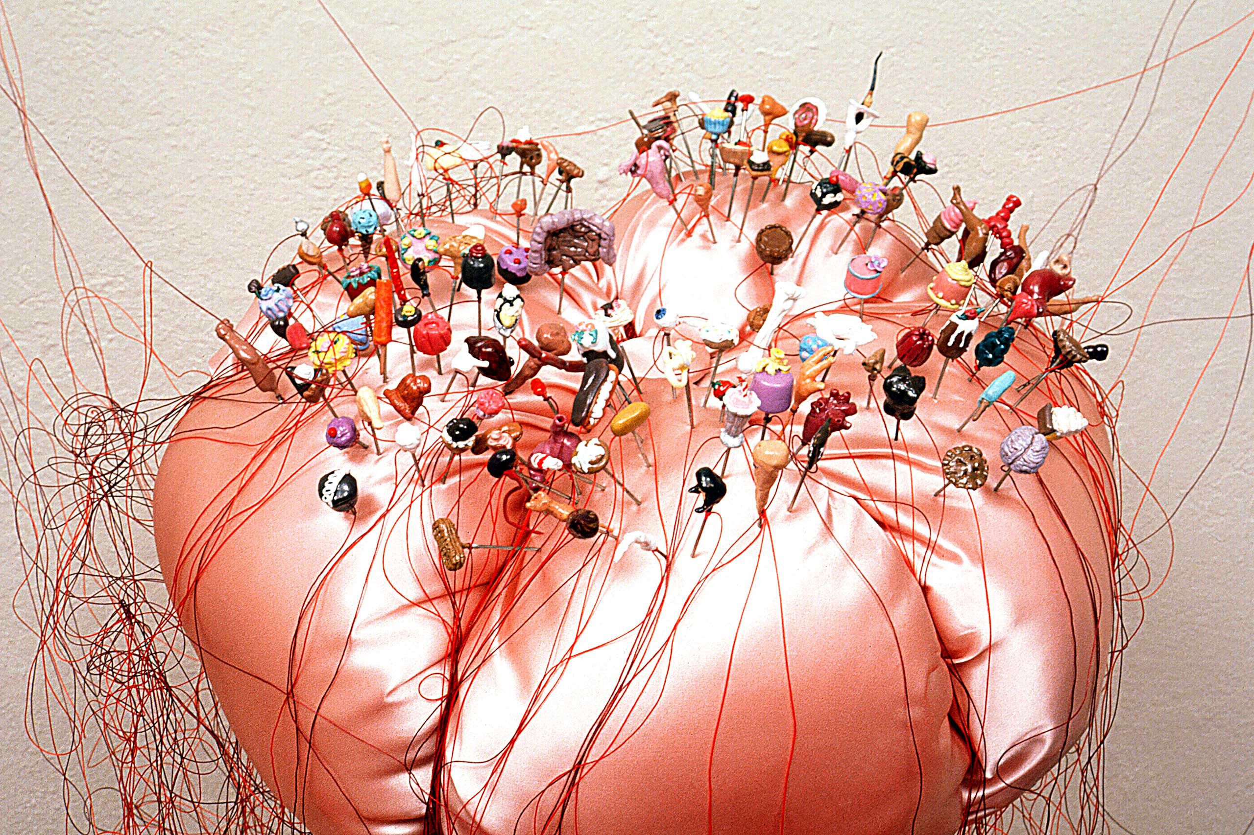 wall and floor mounted sculpture of bread, fabric, polymer clay, steel and thread giant pin cushion with tiny food pins and bread dolls