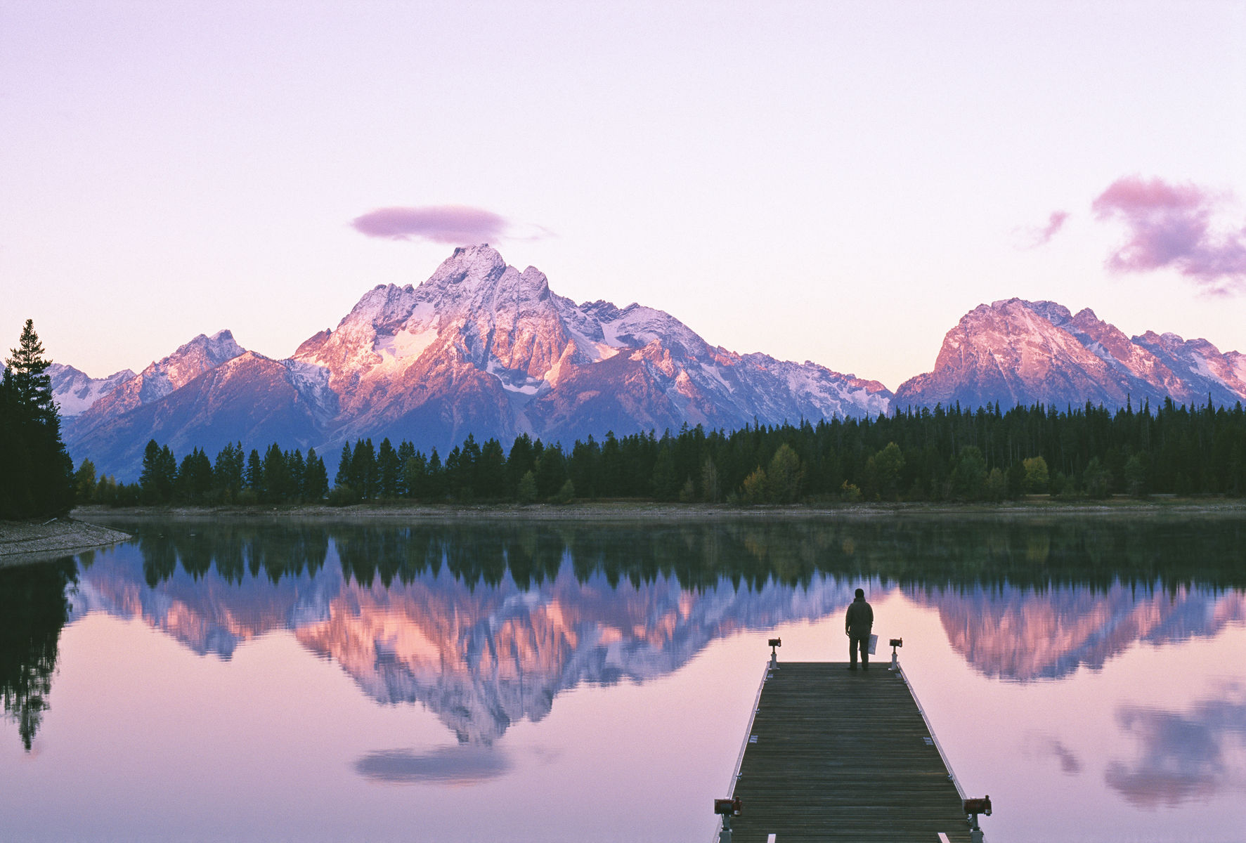 USA,Wyoming, Grand Tetons National Park,person on pier looking out at mountain range. Getty Images #73273005 Grand Teton National Park, Mount Moran, Jackson Lake, person standing on dock near lake
