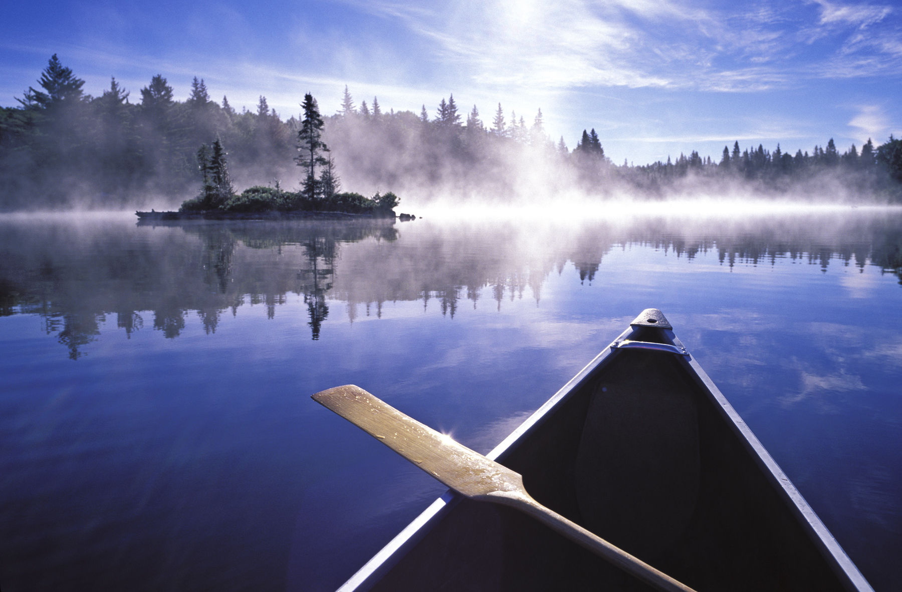 Canada, Ontario, Algonquin Provincial Park,  canoe and mist at sunrise on Little Doe Lake. Getty Images #EB9925-002 Algonquin Provincial Park,  canoe and mist at sunrise