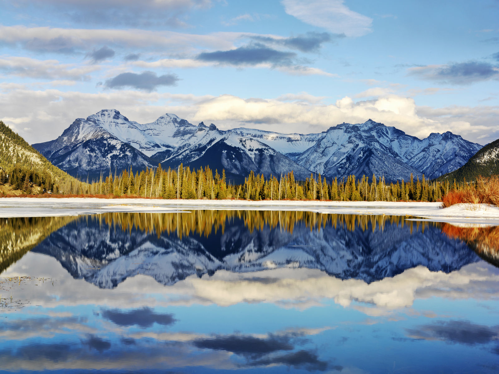 Canada, Alberta, Banff, Banff National Park, snow covered mountains and lake. Getty Images # sb10068112h-001 Canada, Alberta, Banff, Banff National Park, snow covered mounta