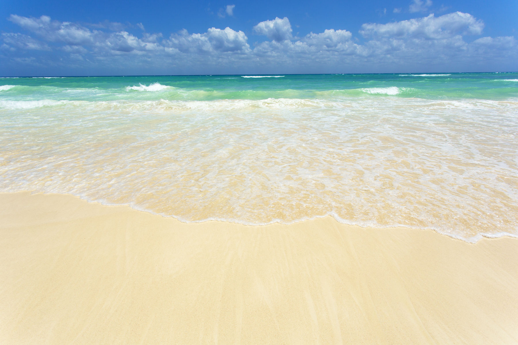 Mexico,Playa del Carmen, surf on white sandy beach,wide angle view surf on white sandy beach