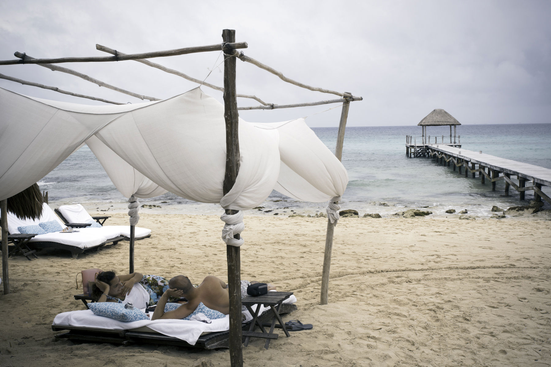Playa del Carmen beach,couple relaxing under a canopy Playa del Carmen beach,couple relaxing under a canopy