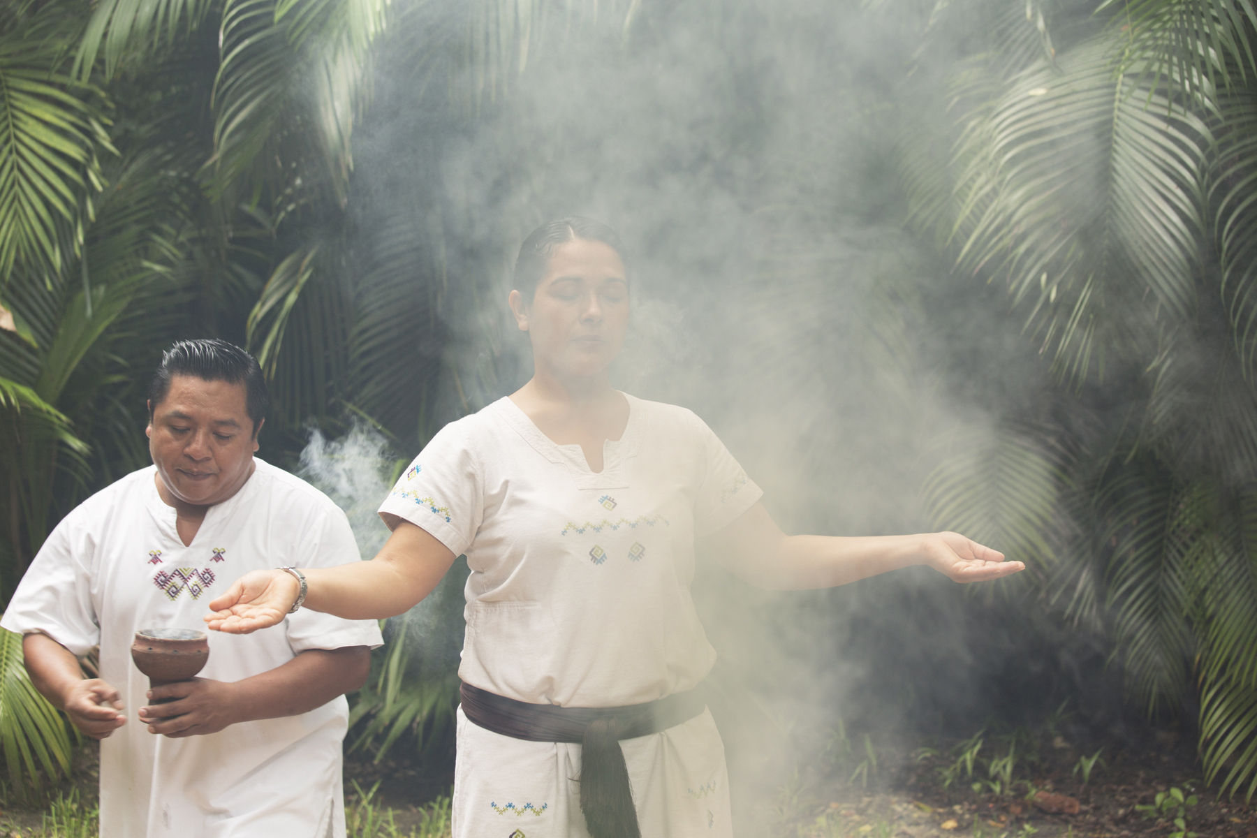 spiritual cleansing in preparation for a Temescal ( sweat lodge ) shaman preparing woman for a temescal (sweatlodge)
