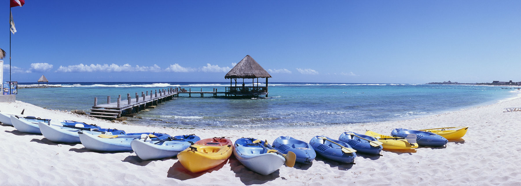 Mexico Quintana Roo Yucatan Peninsula Akumal Mayan Riviera pier with palapa jutting out to the water from the beach with kayaks lined on shore of beach at dawn. Alamy #A9AW6X Akumal Mayan Riviera pier with palapa jutting out to the water f