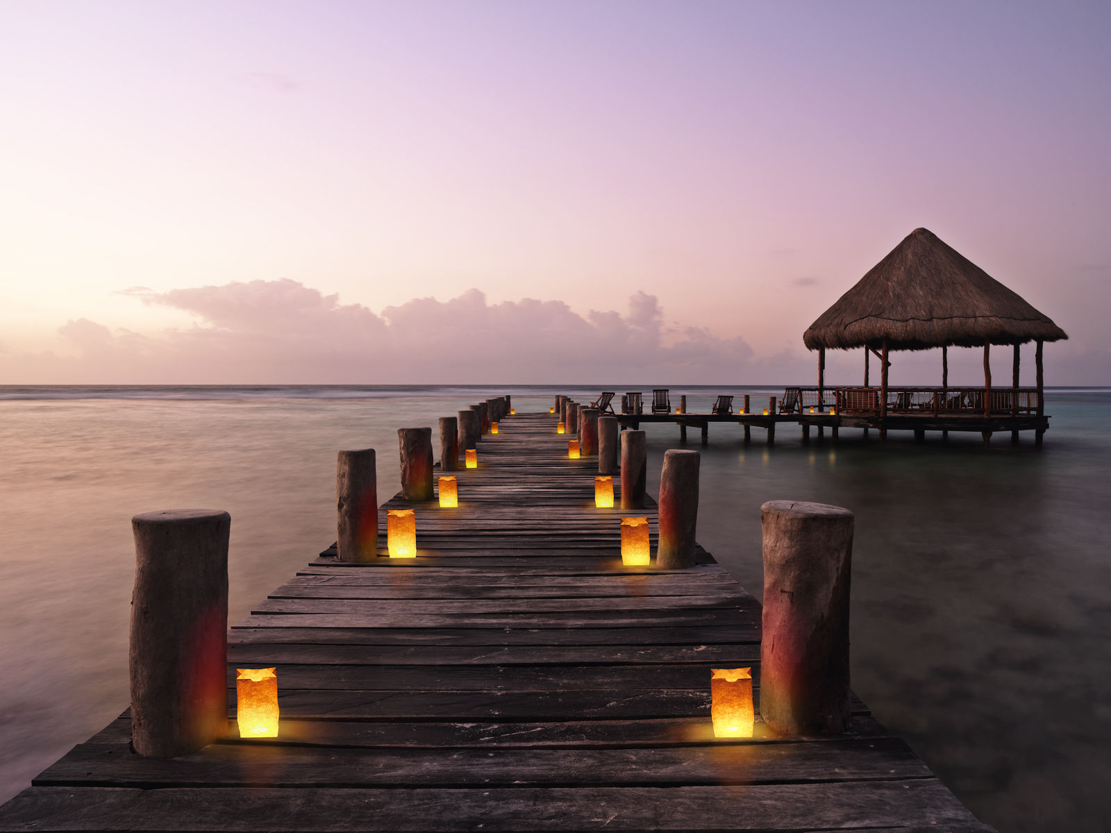 Akumal Mayan Riviera. Getty Images #200544943-001 Mexico, Quintana Roo, pier with palapa jutting into water, dusk