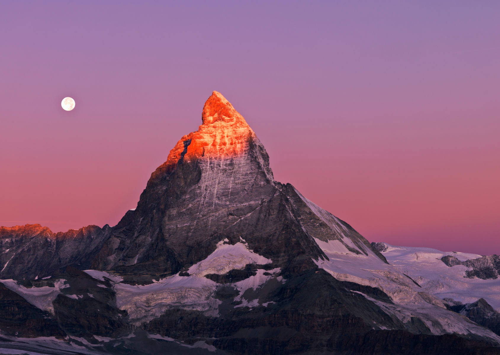 Switzerland, Valais Canton, Zermatt, Mt Matterhorn, Mountain peak covered with snow and moon setting over the Matterhorn at dawn. Getty Images #128040898 Switzerland Valais Zermatt the Gornergrat