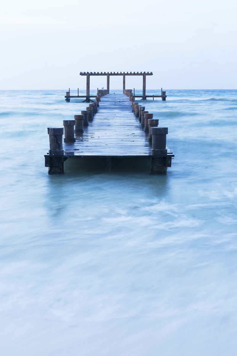 Mexico,Playa del Carmen,pier jutting out to the sea separated from the shore. Getty Images # 173182134 pier jutting out into the sea