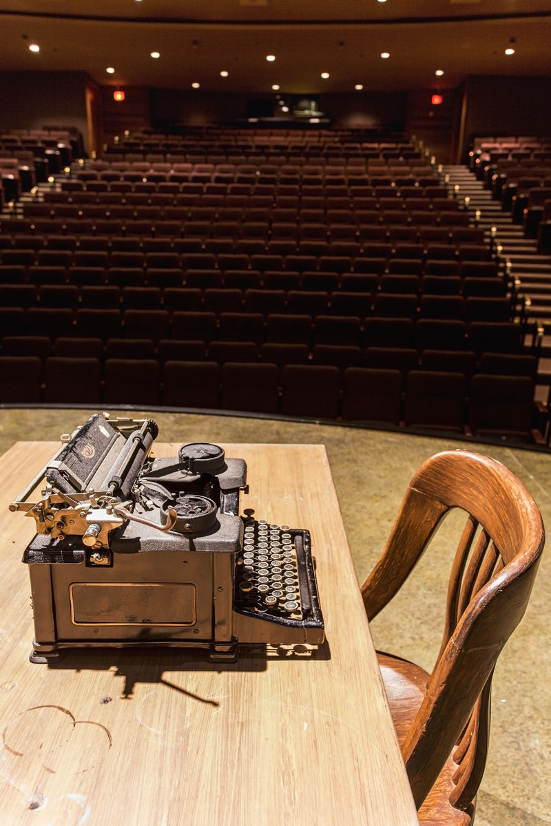 old fashion type writer on stage with empty theatre seats old fashion type writer on stage with empty theatre seats