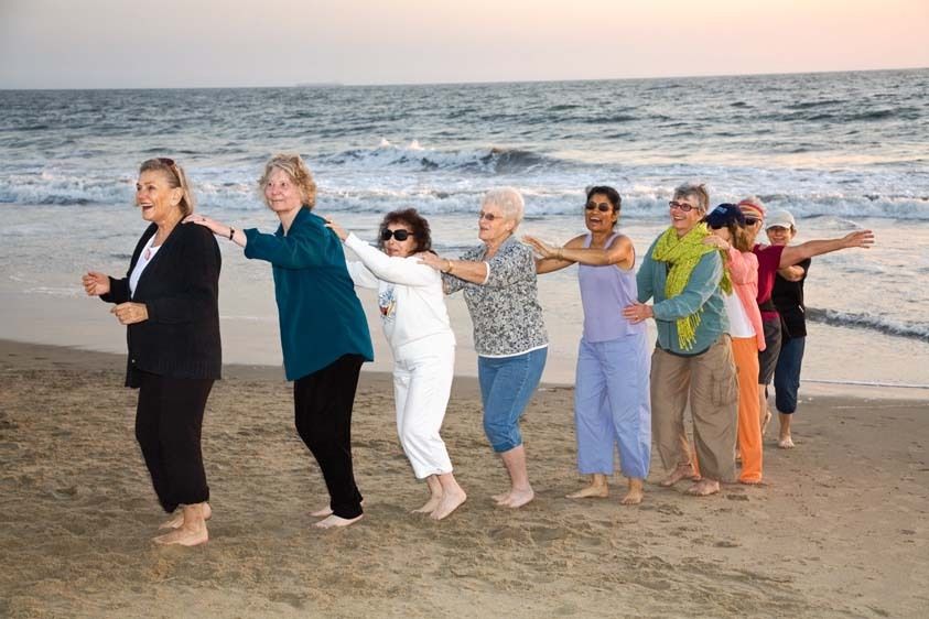 Group of mature women mixed ethnicity in lCongo lineup for class dancing on Playa del Rey Beach in Los Angeles, CA. Dance exercise group of senior women at beach