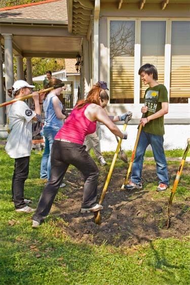 Students of high school and college groups dig with shovels for water prevention and drainage project around house in New Orleans,Louisiana Students volunteer to help water prevention in New Orleans