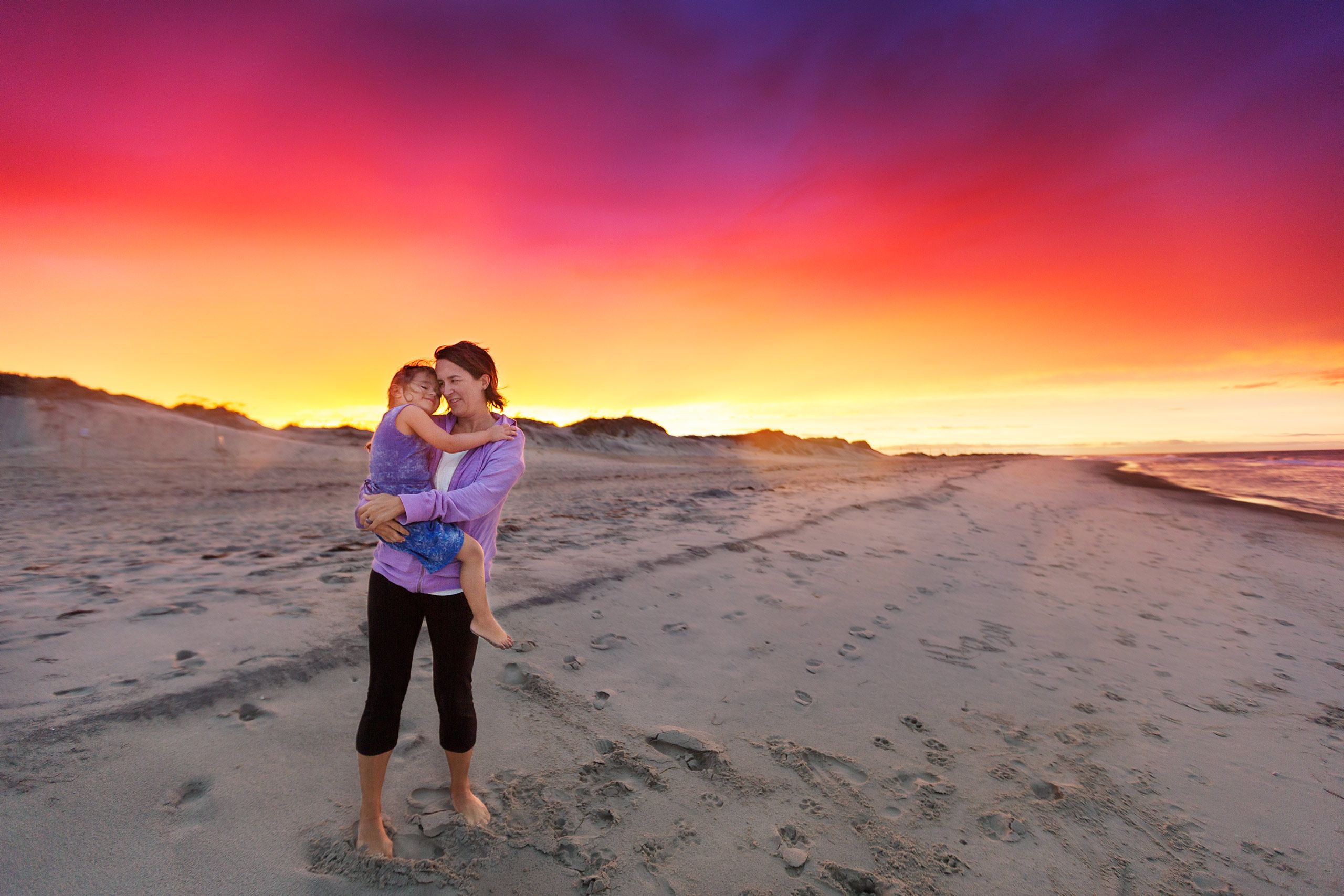 LifeStyle Image - Mom Holding Daughter on Beach at Sunset.jpg