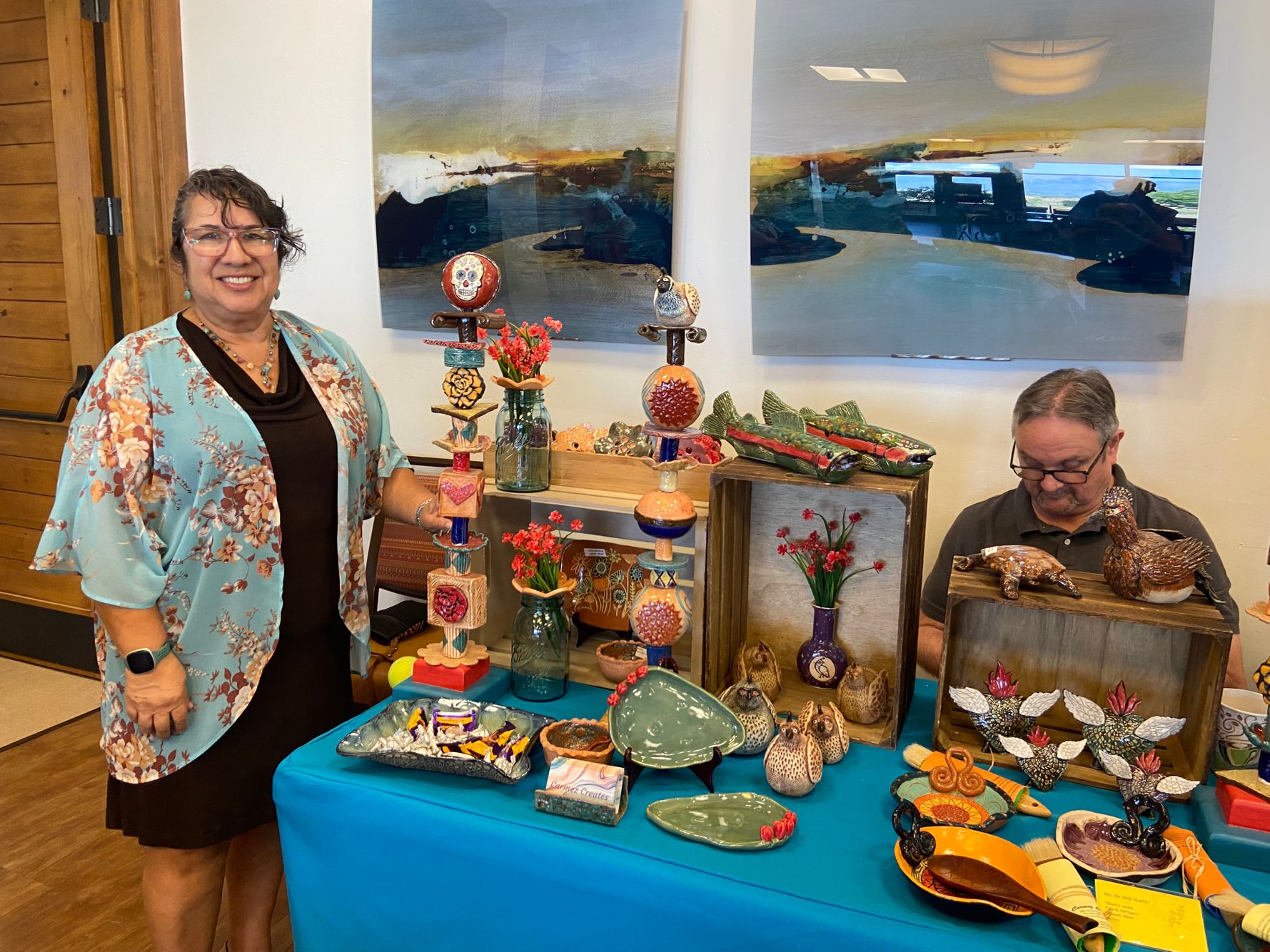 Carmen and Tom Caswell at Carmen's pottery table.jpeg