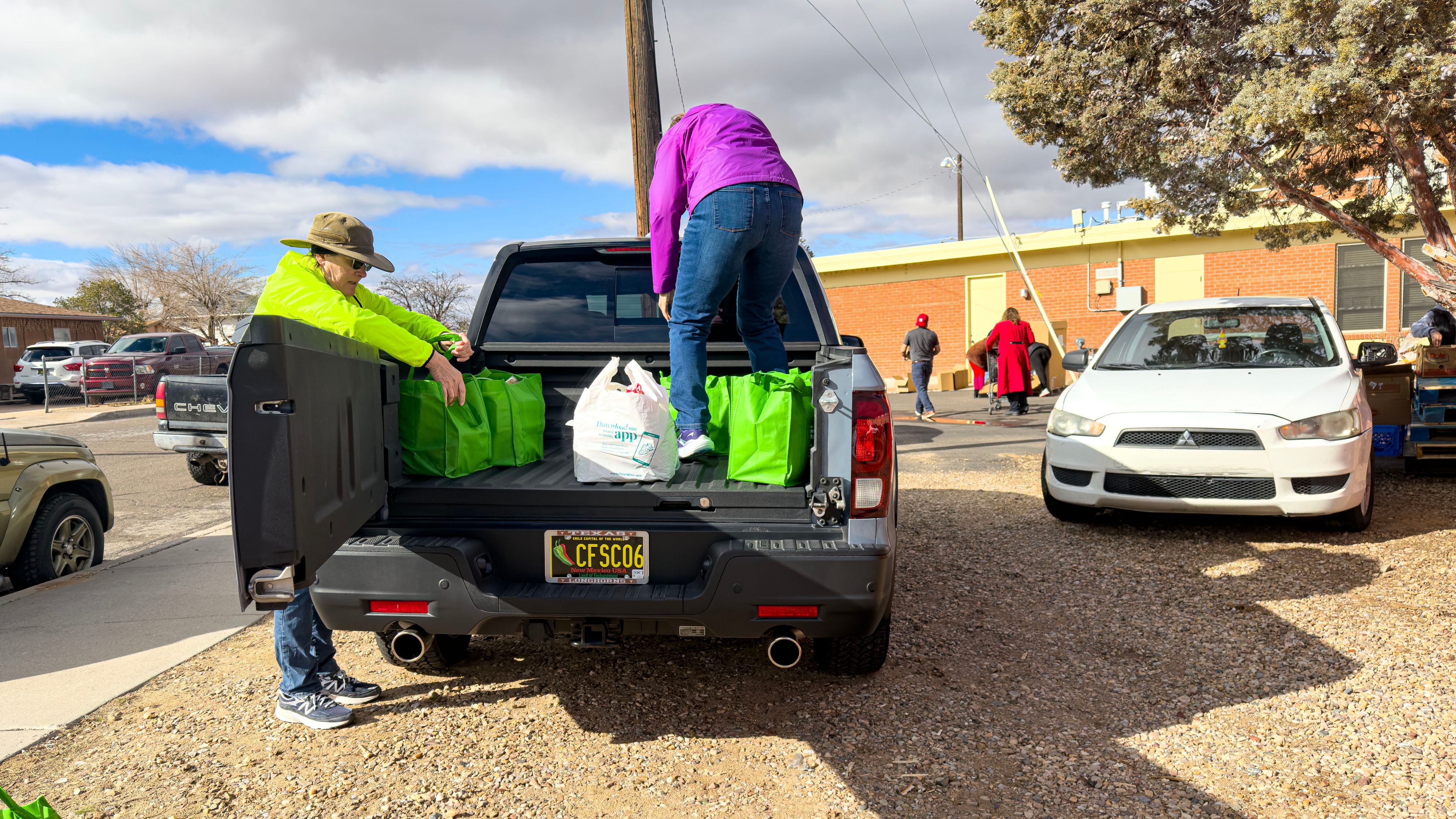 Safety Director Teresa Reinhard and Coordinator Mary Kay Austin unload bags from a truck that was filled to overflowing. 2. IMG_1762 pp.jpg