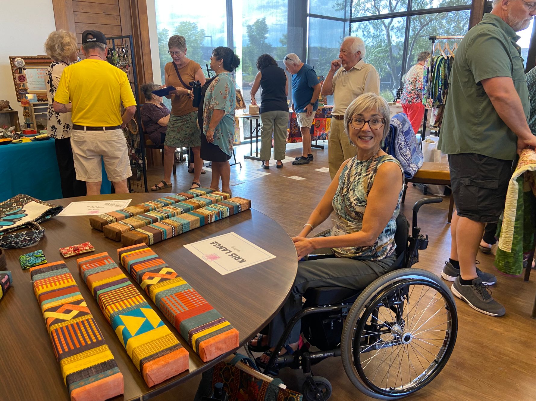 Kris Lange at her quilted design table.jpeg