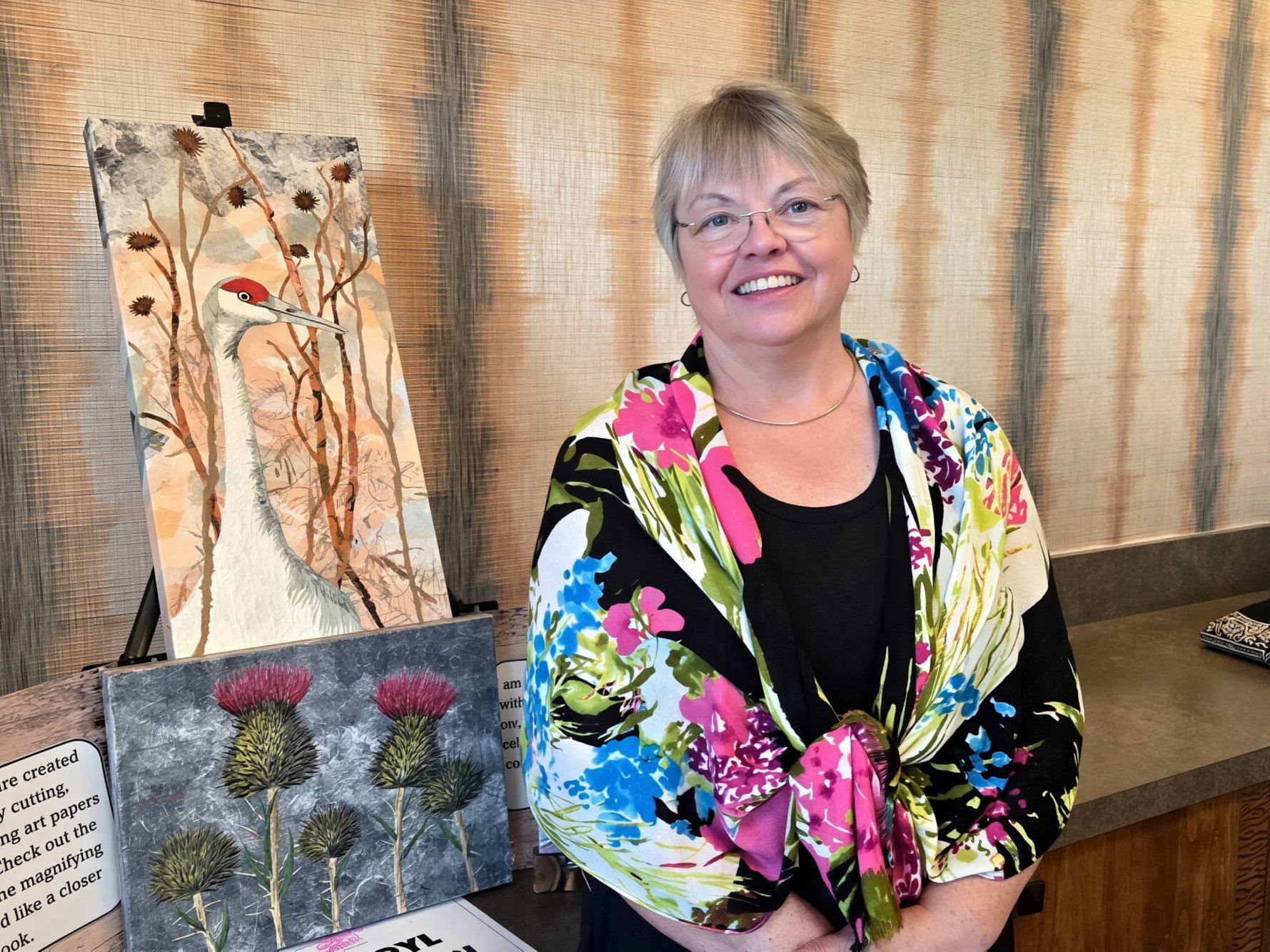 Cheryl Johnson with examples of her collage.jpg