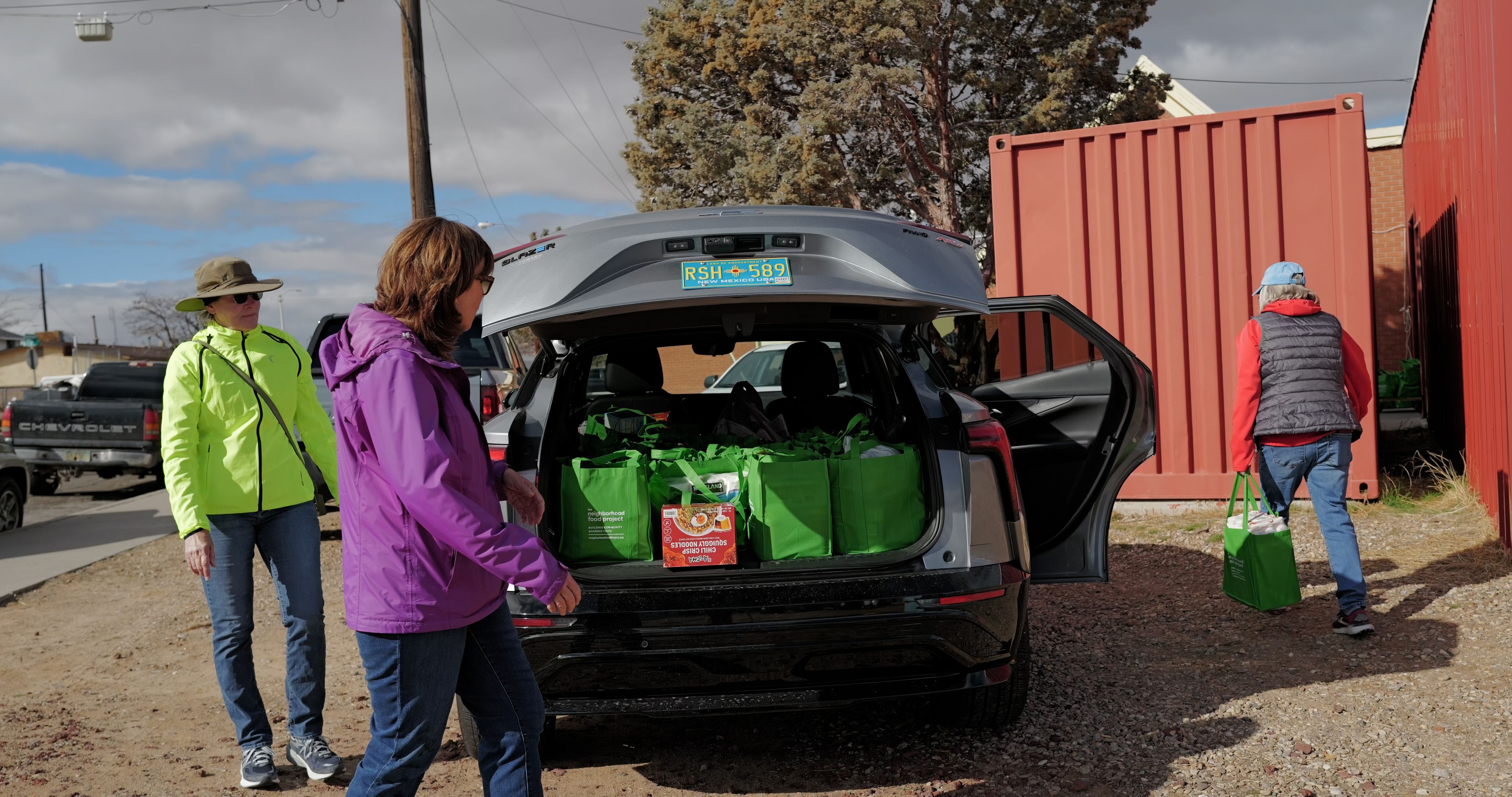 A car filled to the brim with green bags is ready for unloading. 20. L1000665.00_12_41_00.Still002.jpg