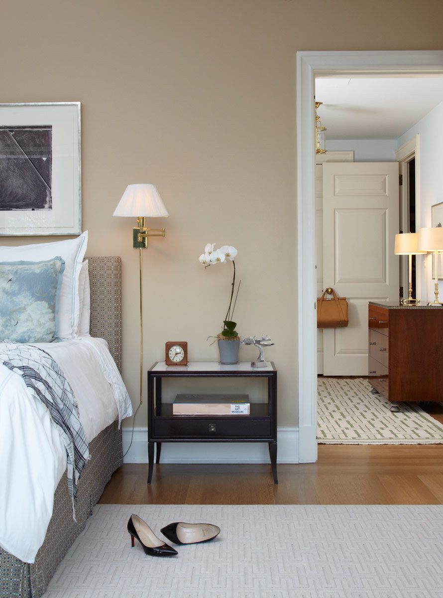 Belsey & Mahla Architects provided architectural and interior design services for this apartment renovation in New York City's newest landmark.The grand living room with dramatic park views has wide stripes on the walls, rich wool draperies on reeded brass rods, and six matching custom bronze coffee tables. A map of Haussmann's Plan for Paris, once in the Louvre's collection, occupies one wall. French aspen paneling and a ribbed oval plaster dome outfit the library; the paneling conceals a secret passage to the master suite.The dining room features French factory lights aimed to illuminate the embroidered silk draperies, and a 1940's French commode with intricate marquetry. The entry vestibule floor is made of French limestone and Saint Laurent marble. A wall-mounted console rests on found metal springs rescued from an antique shop.Paired French doors with beveled glass panes and cremone bolts connect the apartment rooms. The client's collection of modern art masterworks on paper 15 Central Park West