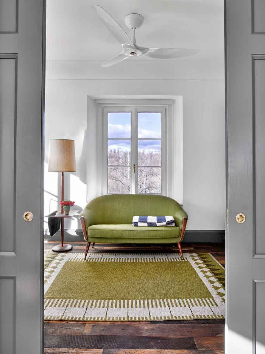 This new stone home recalls centuries -old Huguenot houses built along the Hudson River long ago, while it incorporates the latest technology and materials of the 21st century.  Fieldstone rock facing conceals insulation made from recycled blue jeans and ductwork for geothermal heating and cooling.  The 26" thick exterior walls create commodious windowsills and give a primordial sense of security.  Drawing inspiration from early American center hall plans with rooms flanking a stair on each side, this modern home departs from its Colonial cousin when it comes to light and height.  The living room ceiling soars to 14 feet, and is lit by an enormous Italian Stillnovo chandelier. The kitchen features a fireplace of epic proportions, but every modern convenience is concealed behind elegant stainless steel cabinetry.    Hudson Valley House 13.jpg