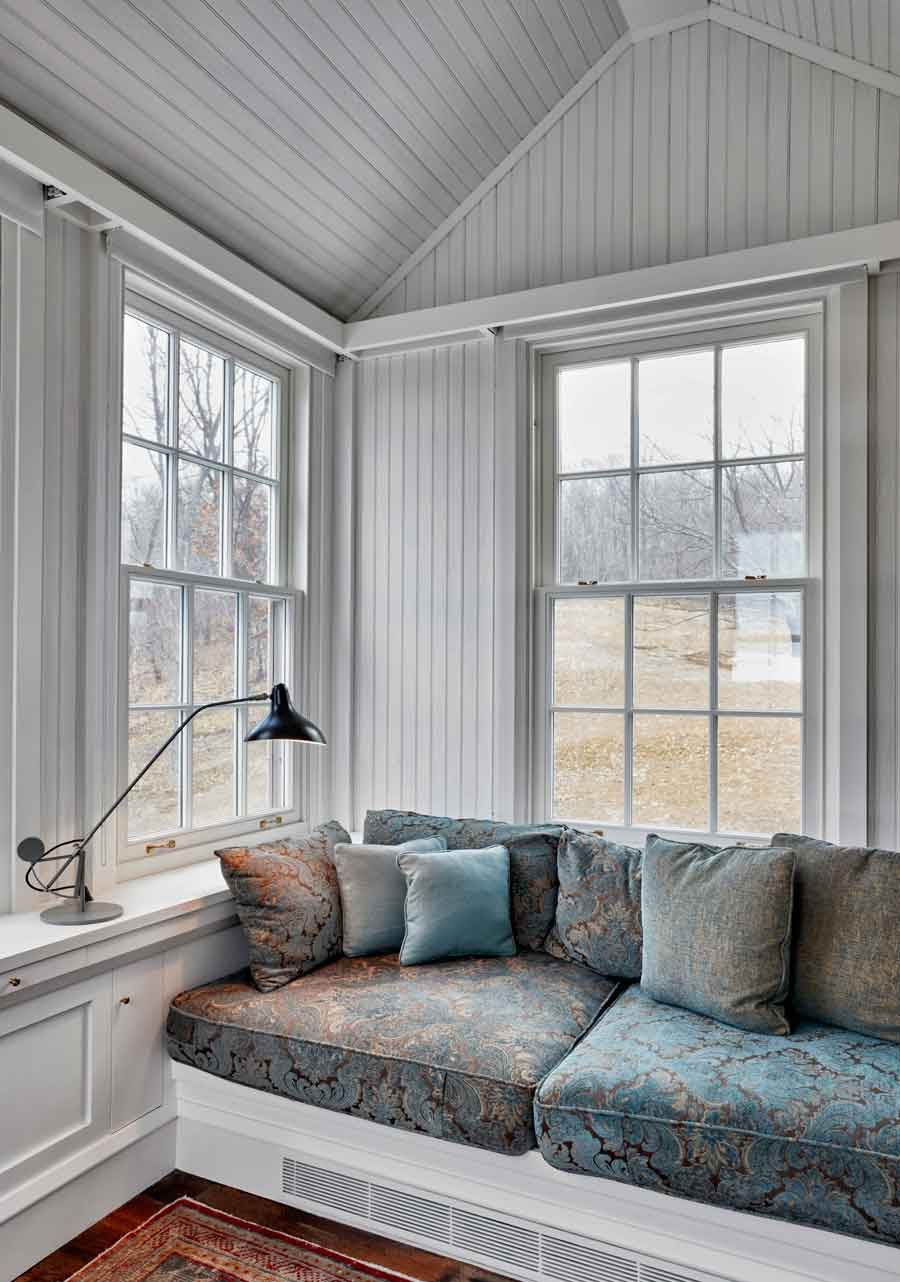 This new stone home recalls centuries -old Huguenot houses built along the Hudson River long ago, while it incorporates the latest technology and materials of the 21st century.  Fieldstone rock facing conceals insulation made from recycled blue jeans and ductwork for geothermal heating and cooling.  The 26" thick exterior walls create commodious windowsills and give a primordial sense of security.  Drawing inspiration from early American center hall plans with rooms flanking a stair on each side, this modern home departs from its Colonial cousin when it comes to light and height.  The living room ceiling soars to 14 feet, and is lit by an enormous Italian Stillnovo chandelier. The kitchen features a fireplace of epic proportions, but every modern convenience is concealed behind elegant stainless steel cabinetry.    Hudson Valley House 6.jpg