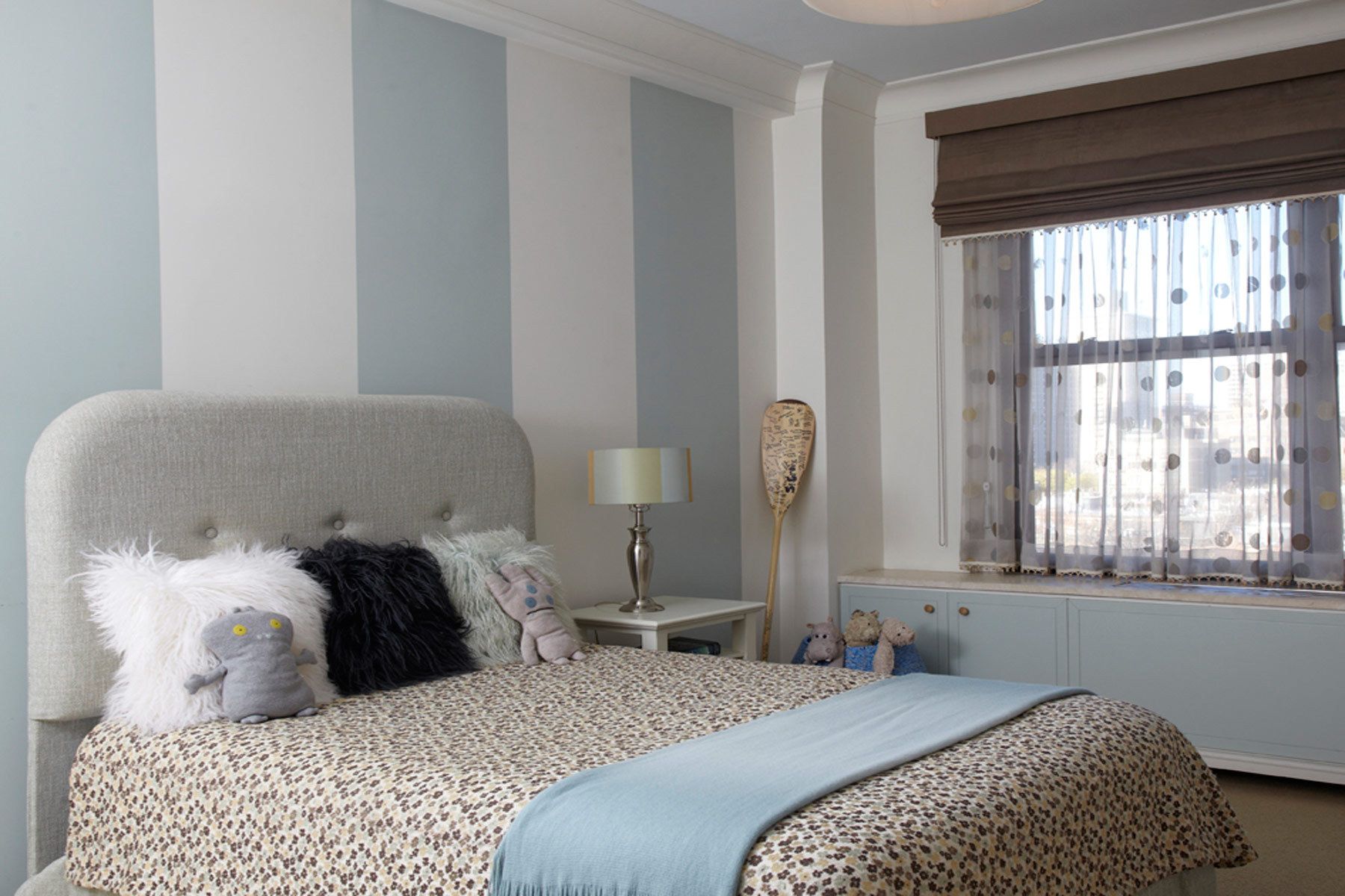 This apartment renovation features rich nut-wood veneers, walnut for the doors and pecan for the kitchen cabinetry, complemented with outsized patterned wallpaper in the entry vestibule and den.  The gallery is furnished with a Serge Mouille chandelier casting light on the silver leafed ceiling, a bronze wall-mounted BDDW vacuum tube clock, and a shagreen-fronted Roman Thomas console.Construction was completed in 2006, and Belsey & Mahla Architects continues to provide design services to the owners. West 86th Street