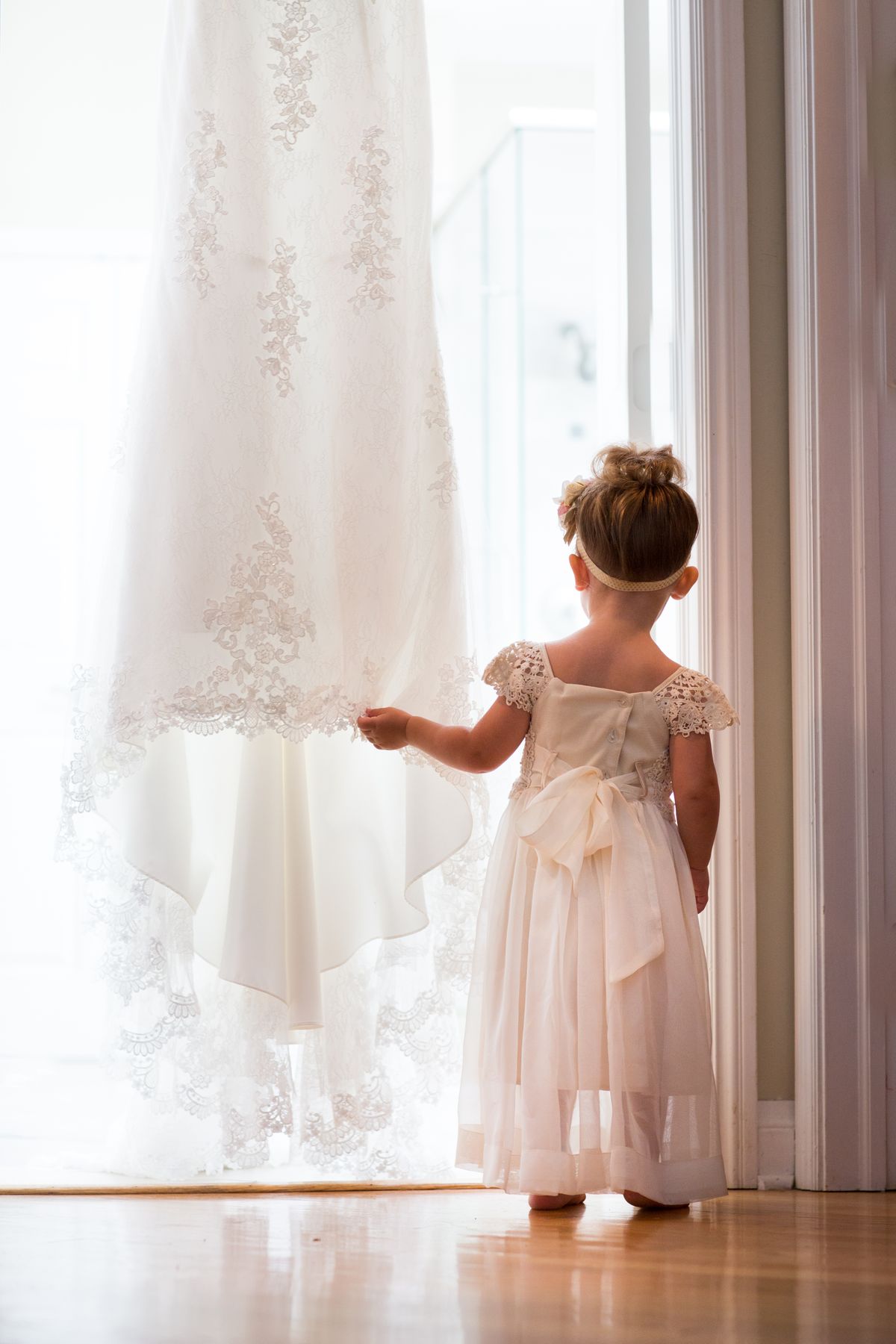 Flower Girl Looking out Window - CampBride onsite bridal hair and makeup in Minnesota Flower Girl Looking out Window - CampBride