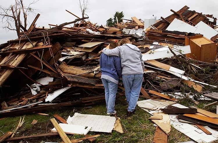 "I promise, we'll find everything" said Amy Brewer, right, hugging her friend Molly Wolfe, left, as the two stand among the debris of what used to be Wolfe's home in Hallsville, Ill.  Wolfe, along with her husband, Todd, and two young children, Rachel and Jacob, took refuge in the hall as Friday night's tornado hit. Todd suffered cuts to his leg, while the rest of the family was unhurt. 1tornado_aftermath_copy