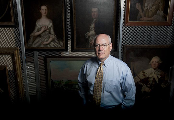 Colonial Williamsburg Chief Curator and Vice President for Collections and Museums Ronald Hurst stands among mid-18th-century paintings that are housed in the paintings storage room at DeWitt Wallace Collections and Conservation Building in Williamsburg, Va., Friday June 10, 2011. The paintings are either awaiting conservation, have already been conserved or are being studied at the moment. The DeWitt facility is one of the best conservation facilities on the East Coast. (Stephanie Oberlander/for Distinction) 1dewitt_collections_022_copy