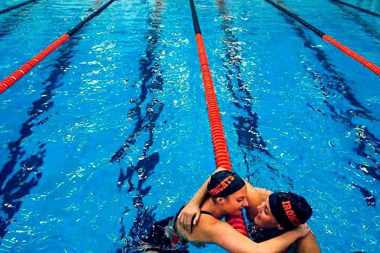 Erica Bouas, left, gives a hug to teammate Kari Turner, after Bouas wins the 200 Yard Individual Medley during the Normal Intercity swim meet. 1Swim_Hug_copy_3