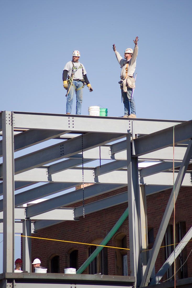 Construction workers on top of stucture at Heartland Financial