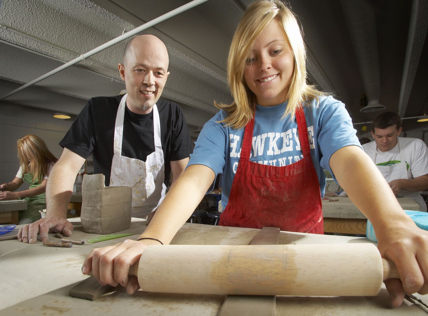 Student and teacher in pottery class at Hawkeye Community College