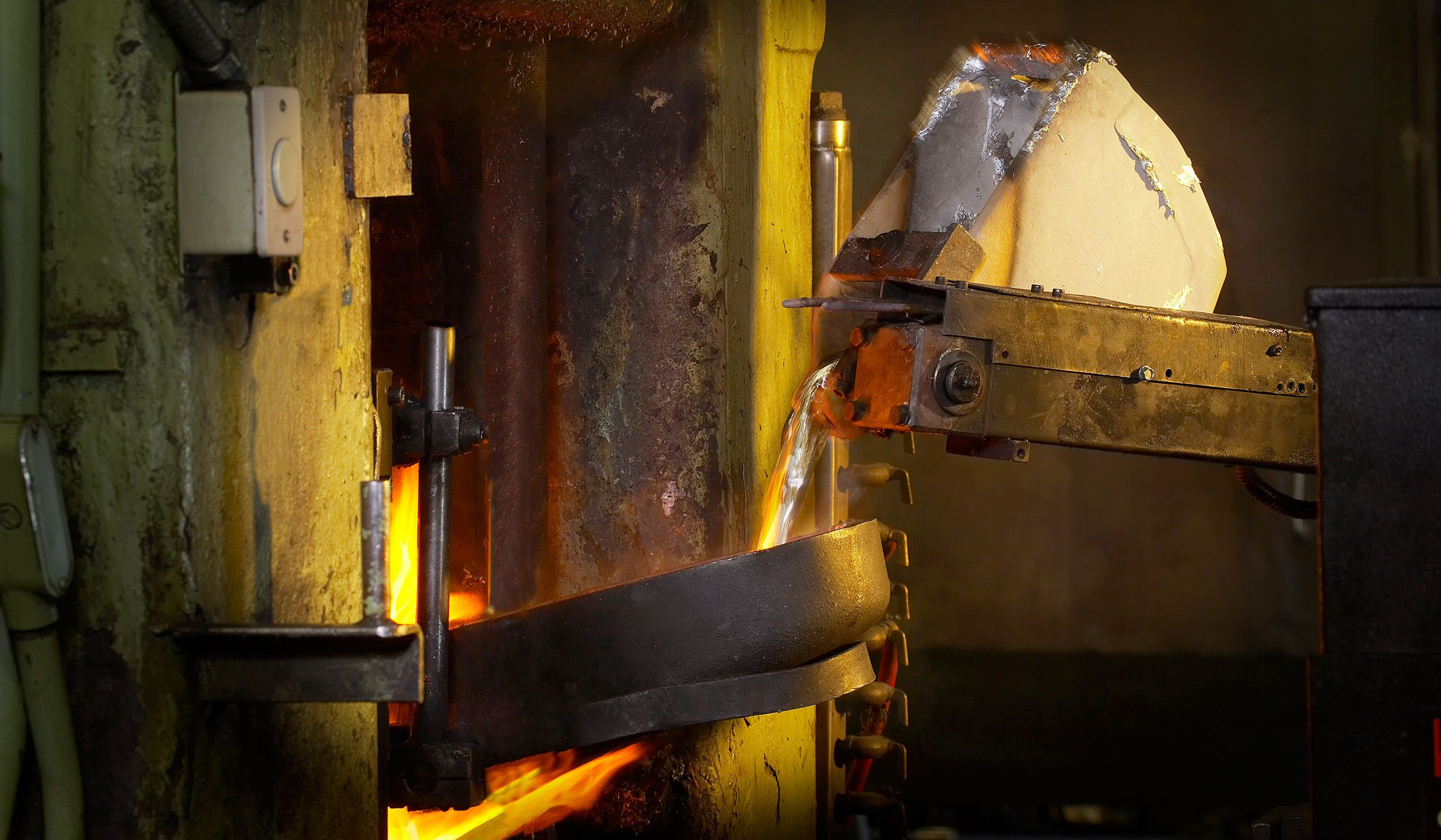 Molten material pouring from hopper in Foundry