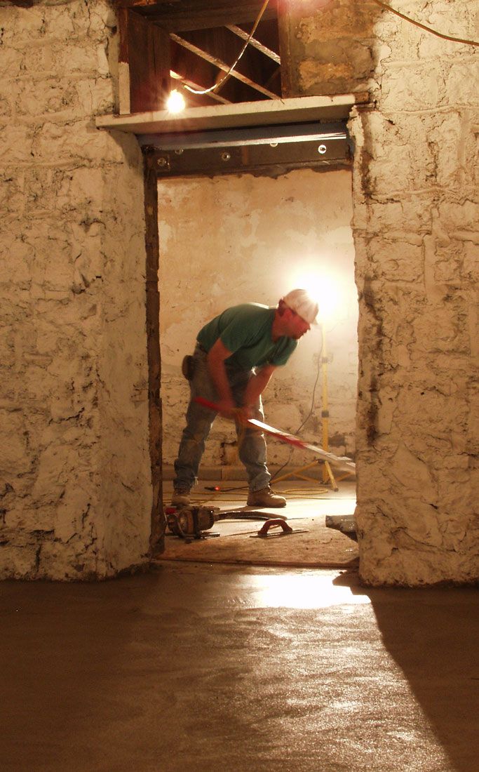 Construction worker cleaning up at Heartland Financial building restoration