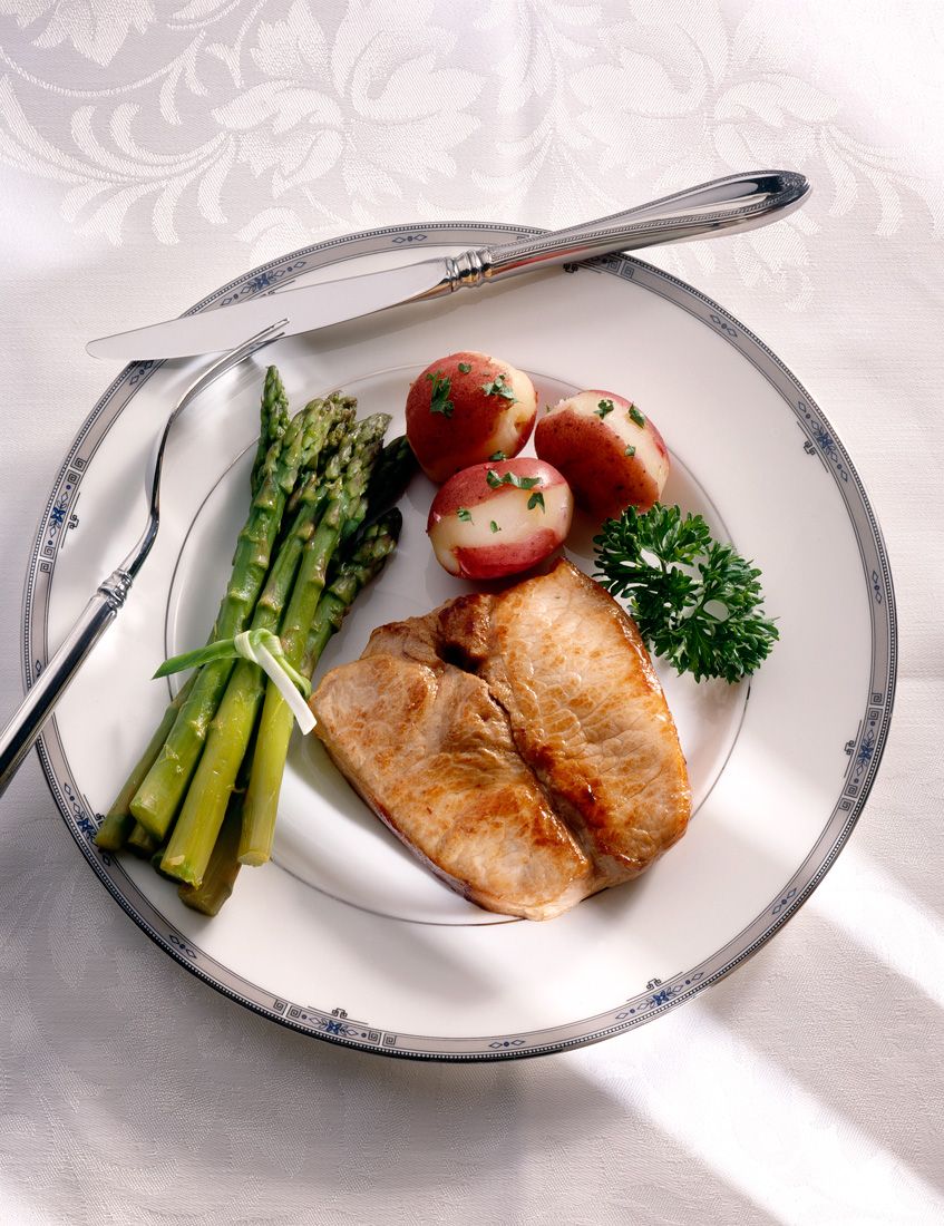 Pork chop asparagus red potatoes food photography