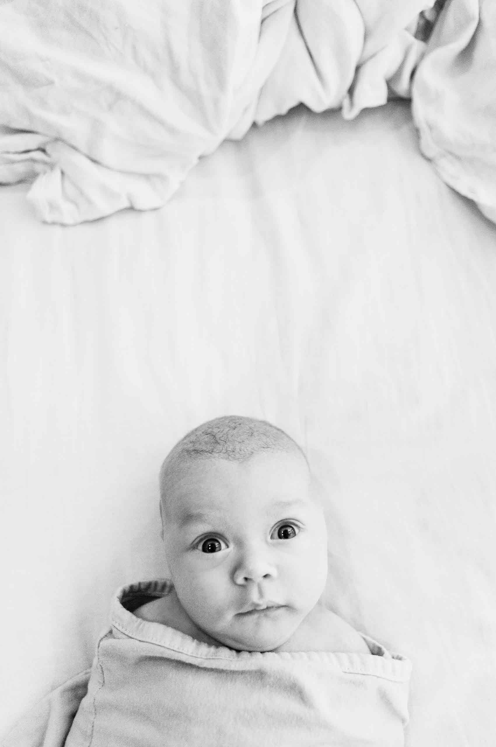 Baby-bed-bundled-curious-bigeyes-bw-HenrikOlundPhotography.jpg