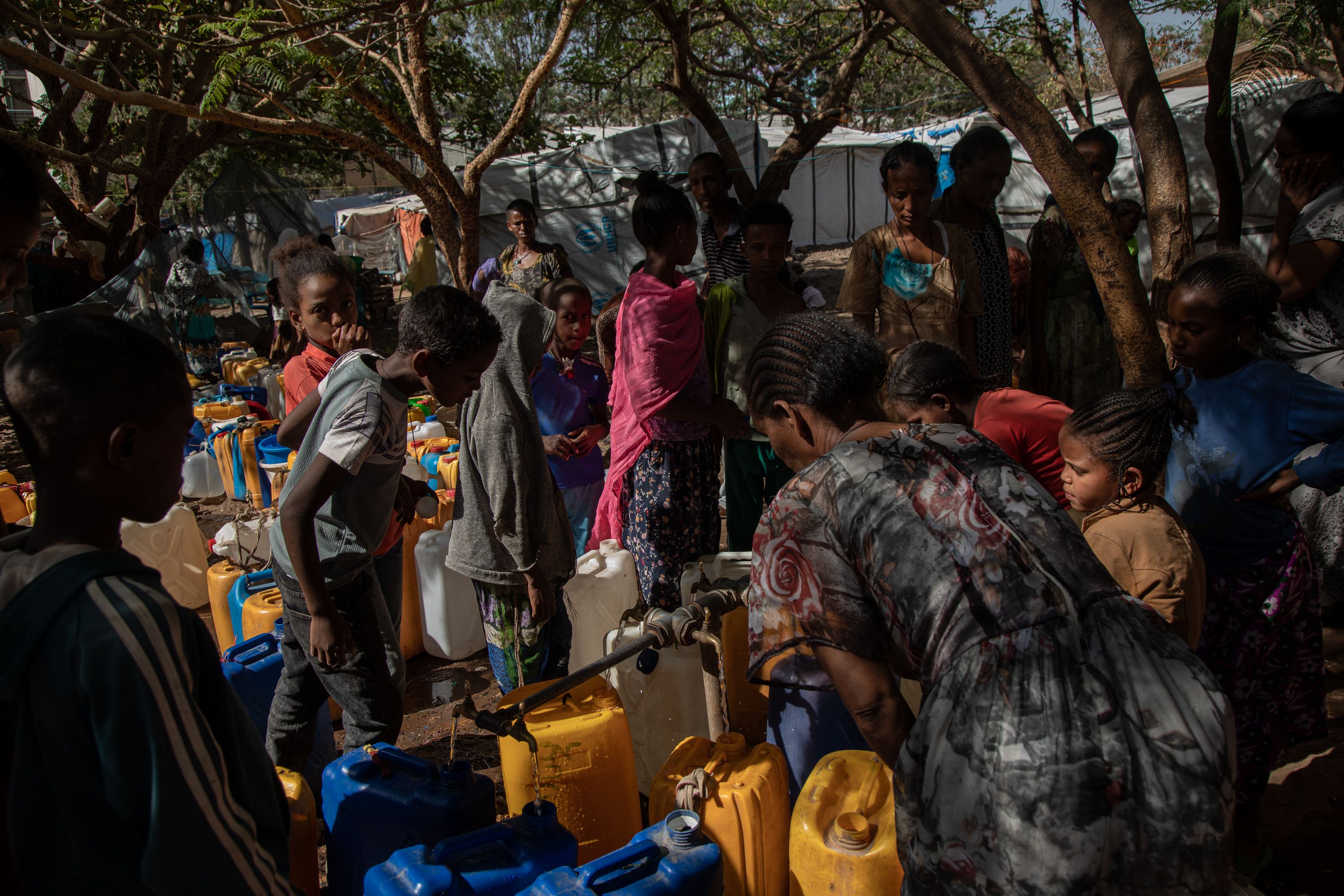 People line up to fill up water containers at a camp for internally displaced persons in Shire, Tigray, Ethiopia. Tigray'sPeacetimeCasualties_04002023-006.jpg