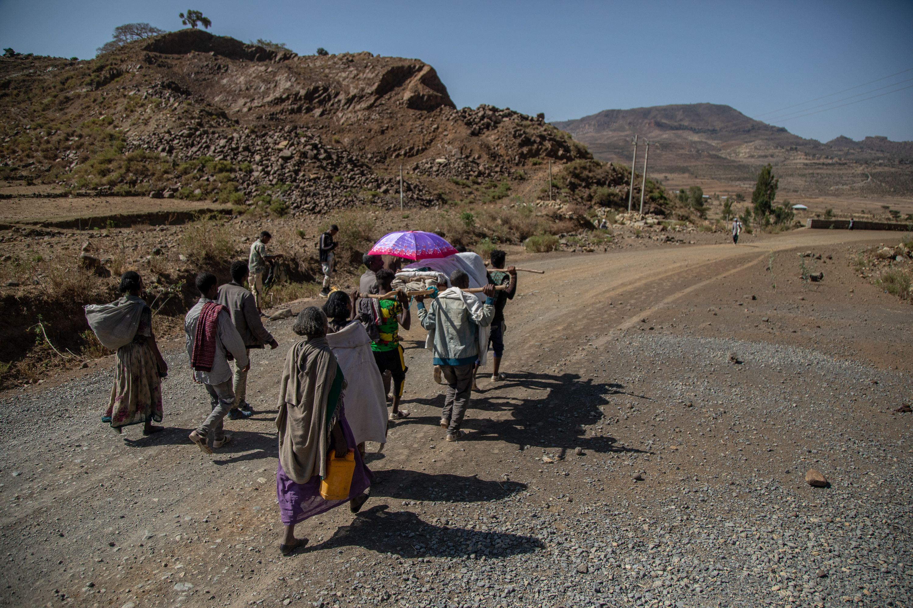 Kalayeta Abadi, 36, who’s undergoing labor, is carried on a traditional stretcher to the closest hospital in Samre, Tigray, Ethiopia. Lack of individual transportation and the destruction of ambulances during the conflict is forcing pregnant women to make hazardous journeys on foot to reach a health clinic during labor or deliver at home alone. Tigray'sPeacetimeCasualties_04002023-015.jpg