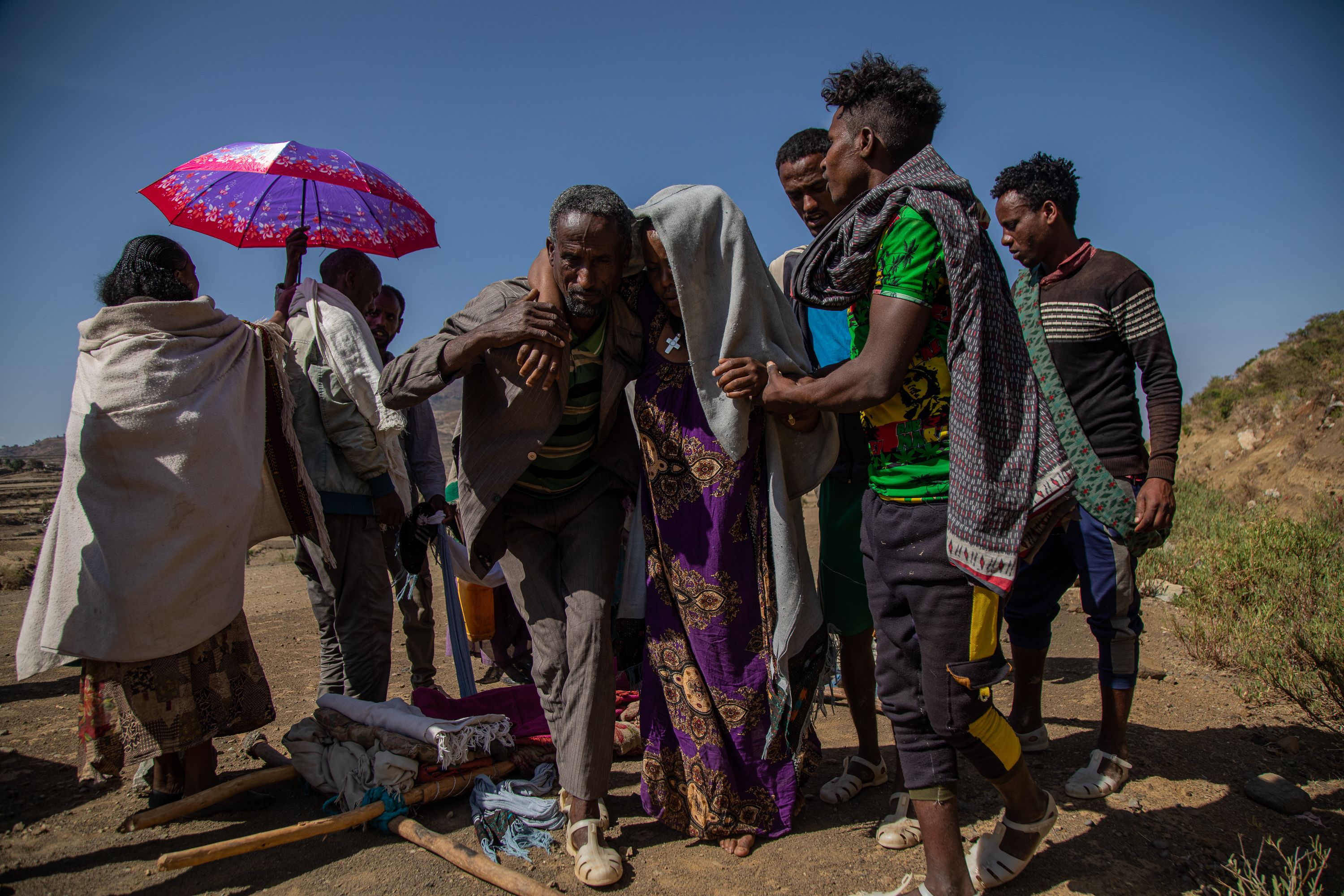 Kalayeta Abadi, 36, who’s undergoing labor, is carried on a traditional stretcher to the closest hospital in Samre, Tigray, Ethiopia. Lack of individual transportation and the destruction of ambulances during the conflict is forcing pregnant women to make hazardous journeys on foot to reach a health clinic during labor or deliver at home alone. Tigray'sPeacetimeCasualties_04002023-014.jpg