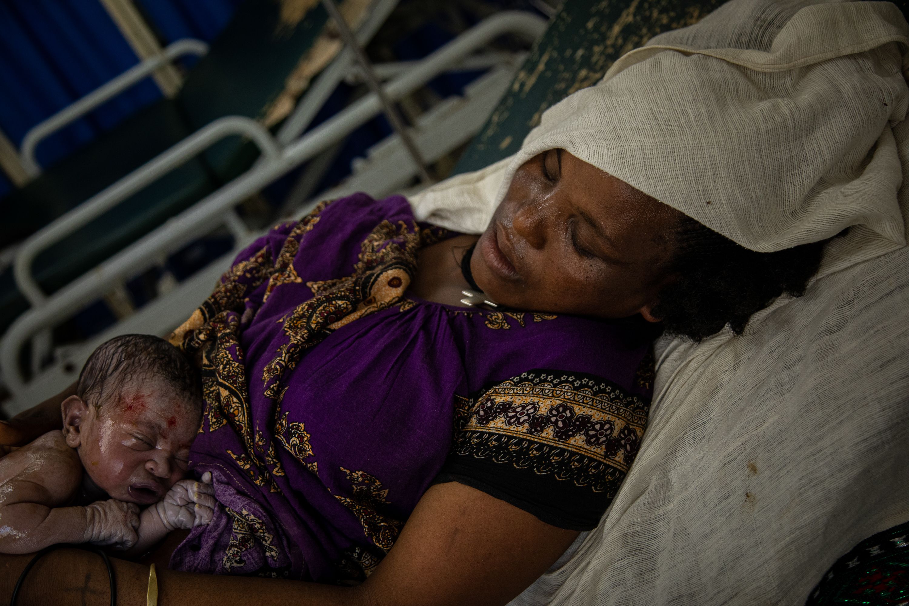Kaleyta Abadi, 36, rests on a delivery bed after giving birth to her first child at Samre Health Center in Tigray, Ethiopia. Maternal mortality rates increased by five-fold compared to data recorded before the conflict began in 2020. The trend is attributed to the lack of accessible health clinics, medicines and medical staff capable of providing services during the conflict, particularly in more rural areas of the region. Tigray'sPeacetimeCasualties_04002023-016.jpg