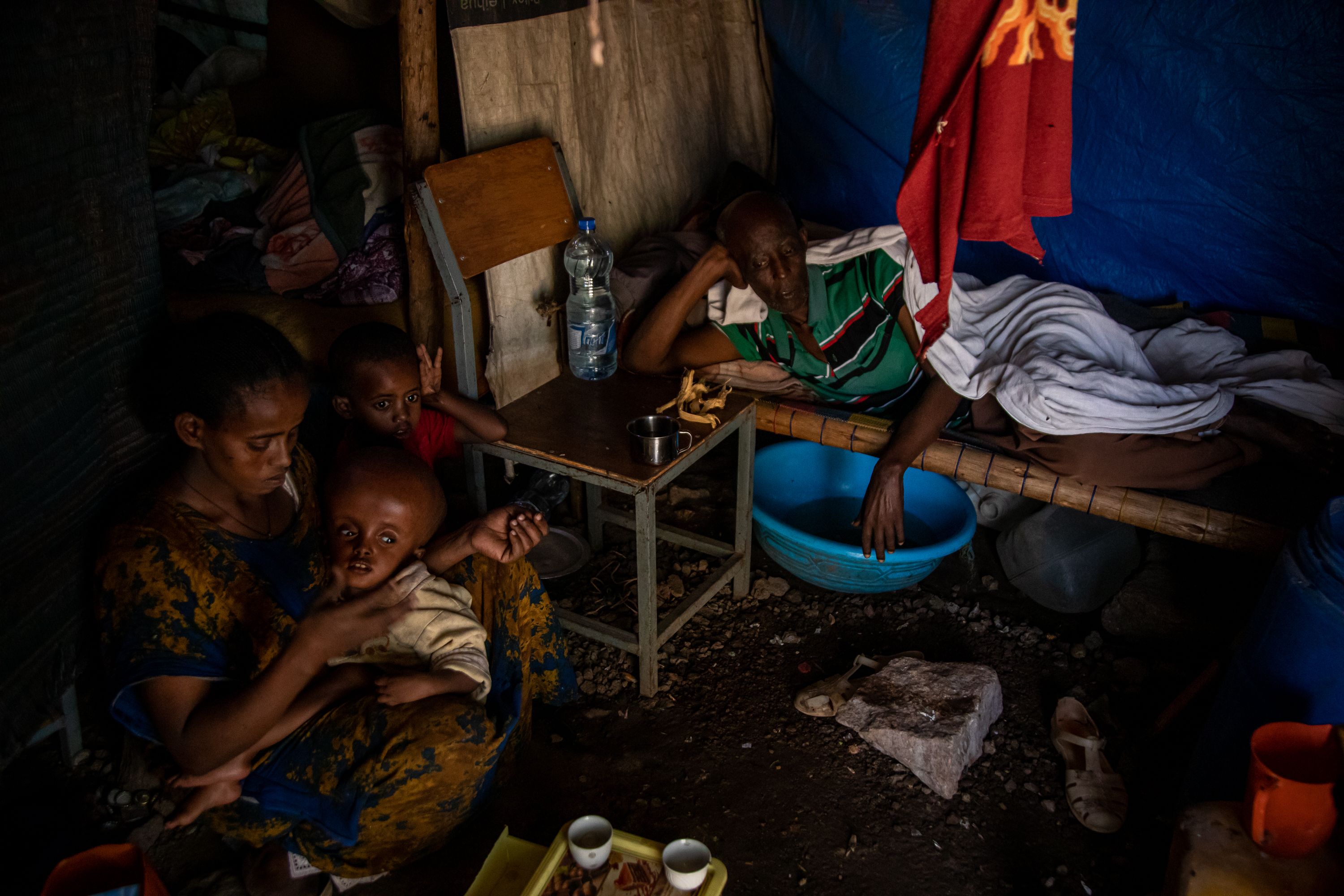 Absey Teka (left), Gebrekidan Alemayoh (right), and their two children at a camp for internally displaced people where other 8,000 people live in Shire, Tigray, Ethiopia. Despite the need for frequent medical checkups, their youngest son, who is diagnosed with macrocephaly, has been unable to see a doctor for two years because of the conflict and the family’s lack of financial resources. Tigray'sPeacetimeCasualties_04002023-011.jpg