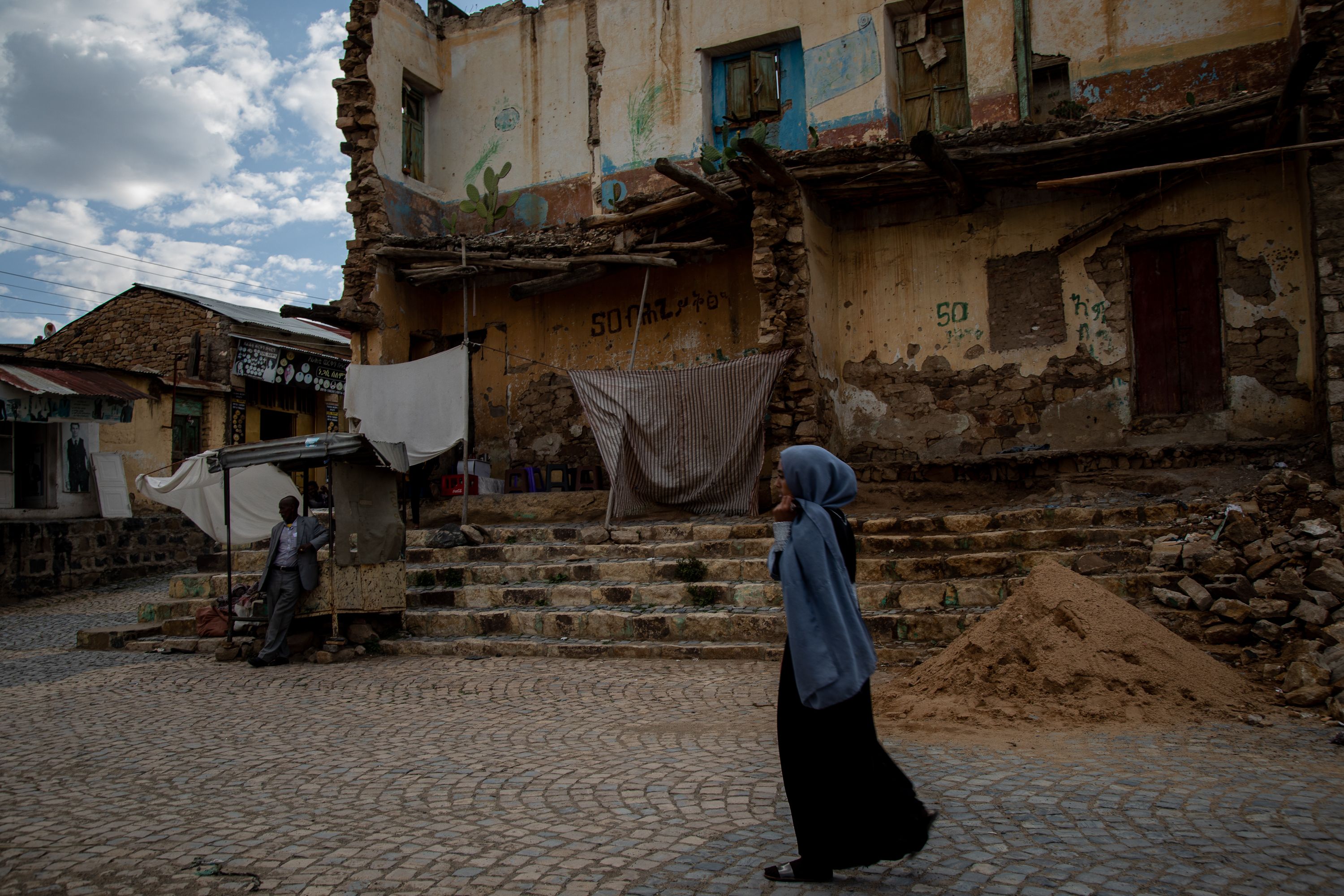 A woman walks through the streets of Adrigrat, Tigray, six months into the cessation of hostilities marked by the signing of the Peace Agreement in Pretoria. Tigray'sPeacetimeCasualties_04002023-009.jpg
