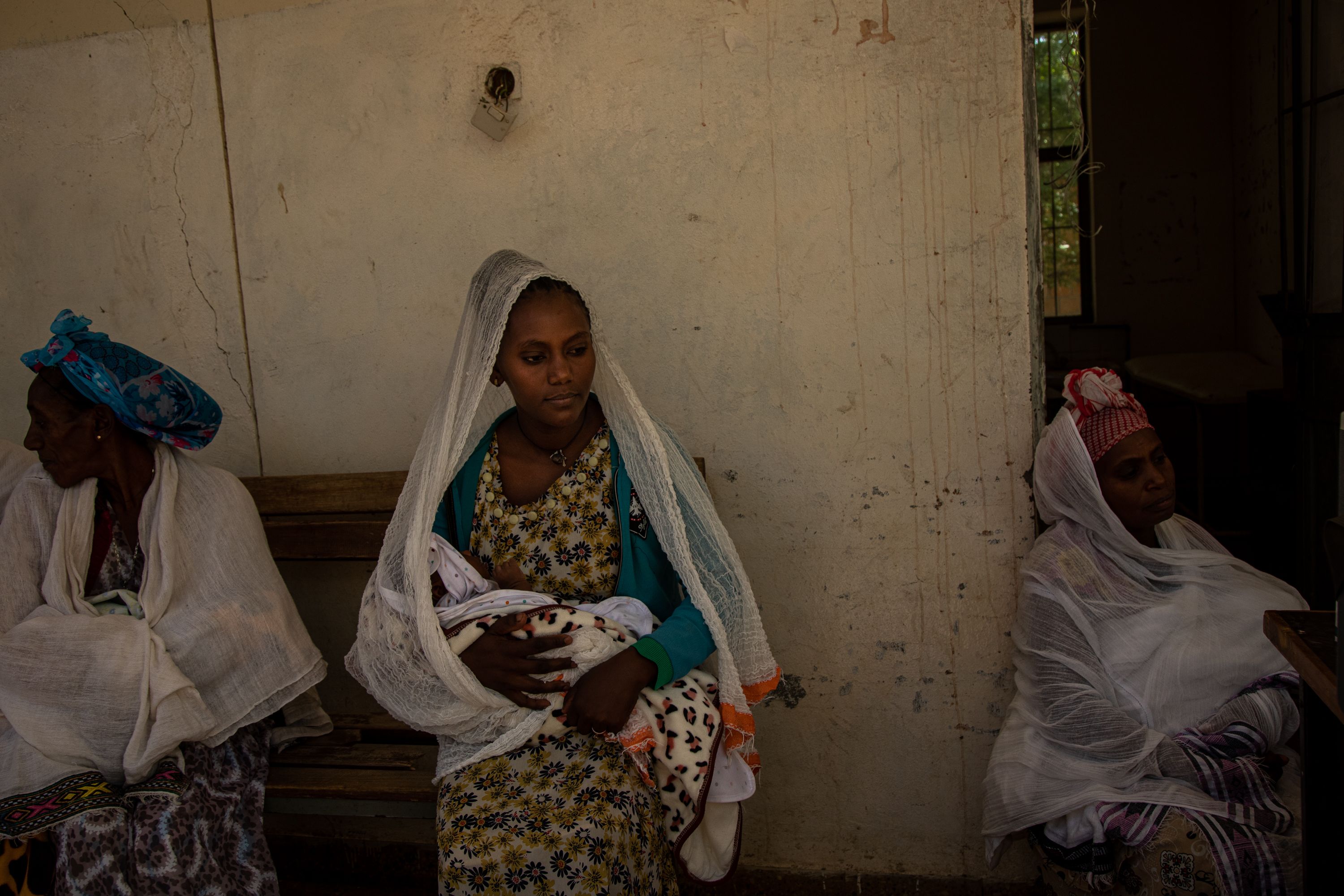 Mothers gather with their children at a clinic run by Save The Children in Fatsi, Eastern Tigray, Ethiopia, for routine vaccinations. With NGOs' help, local health clinics are restarting routine vaccination programs that had been disrupted by the conflict. Childhood immunization levels in the region had dropped to 10 percent in the two years of fighting between the Ethiopian federal government and the TPLF from a previous high of 90 percent. The World Health Organization (WHO) documented a rise in disease outbreaks, including malaria, measles, acute respiratory infections, and other preventable diseases. Tigray'sPeacetimeCasualties_04002023-013.jpg