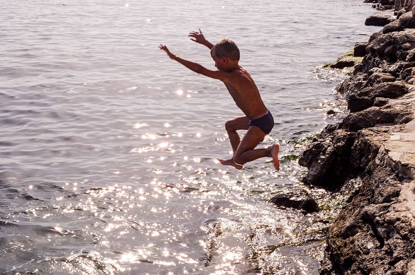 Boy Jumping into Water