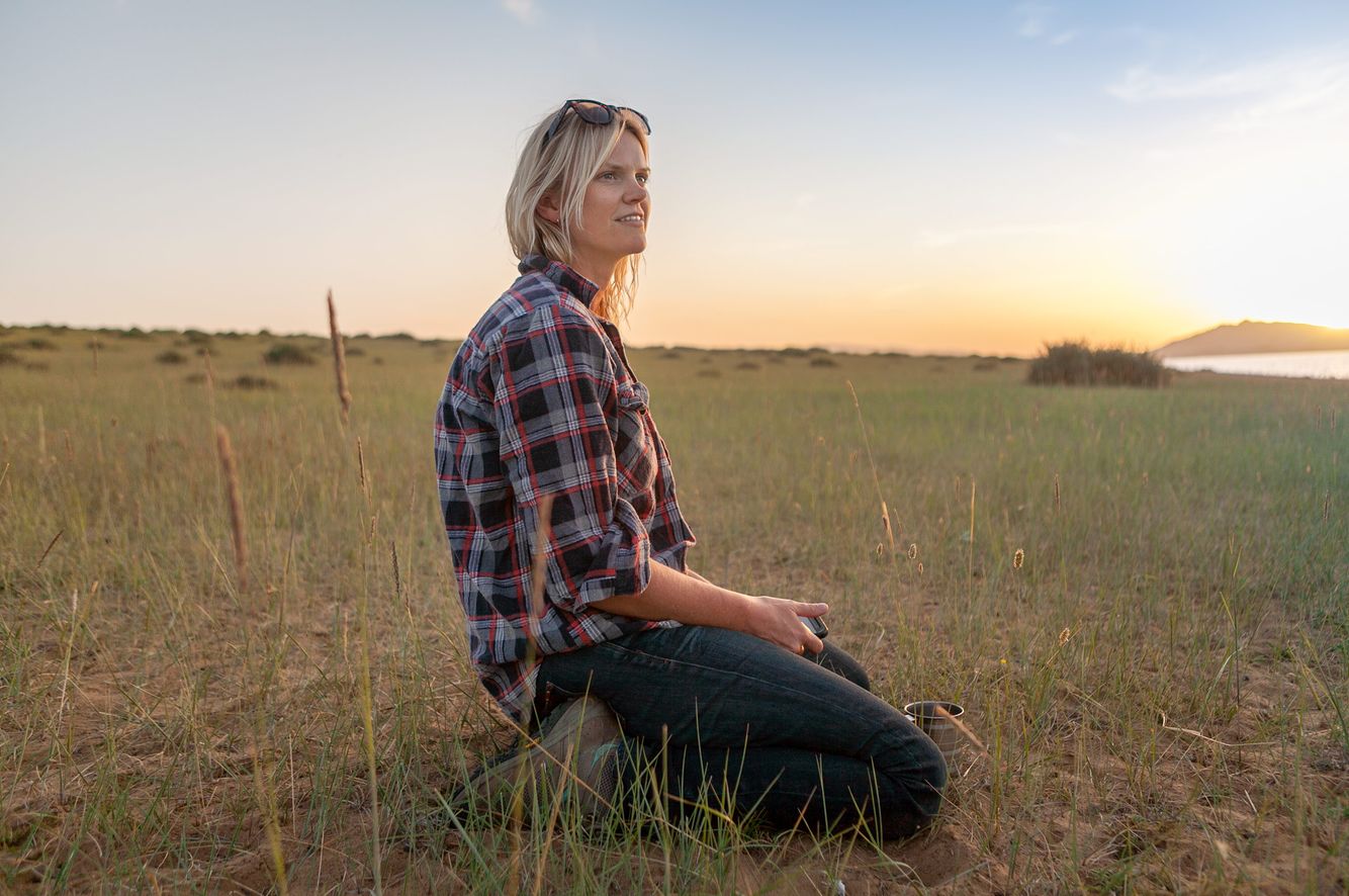 Young Woman Sitting in a  Field