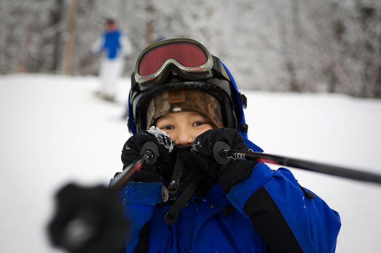Young Skier Playing with Poles