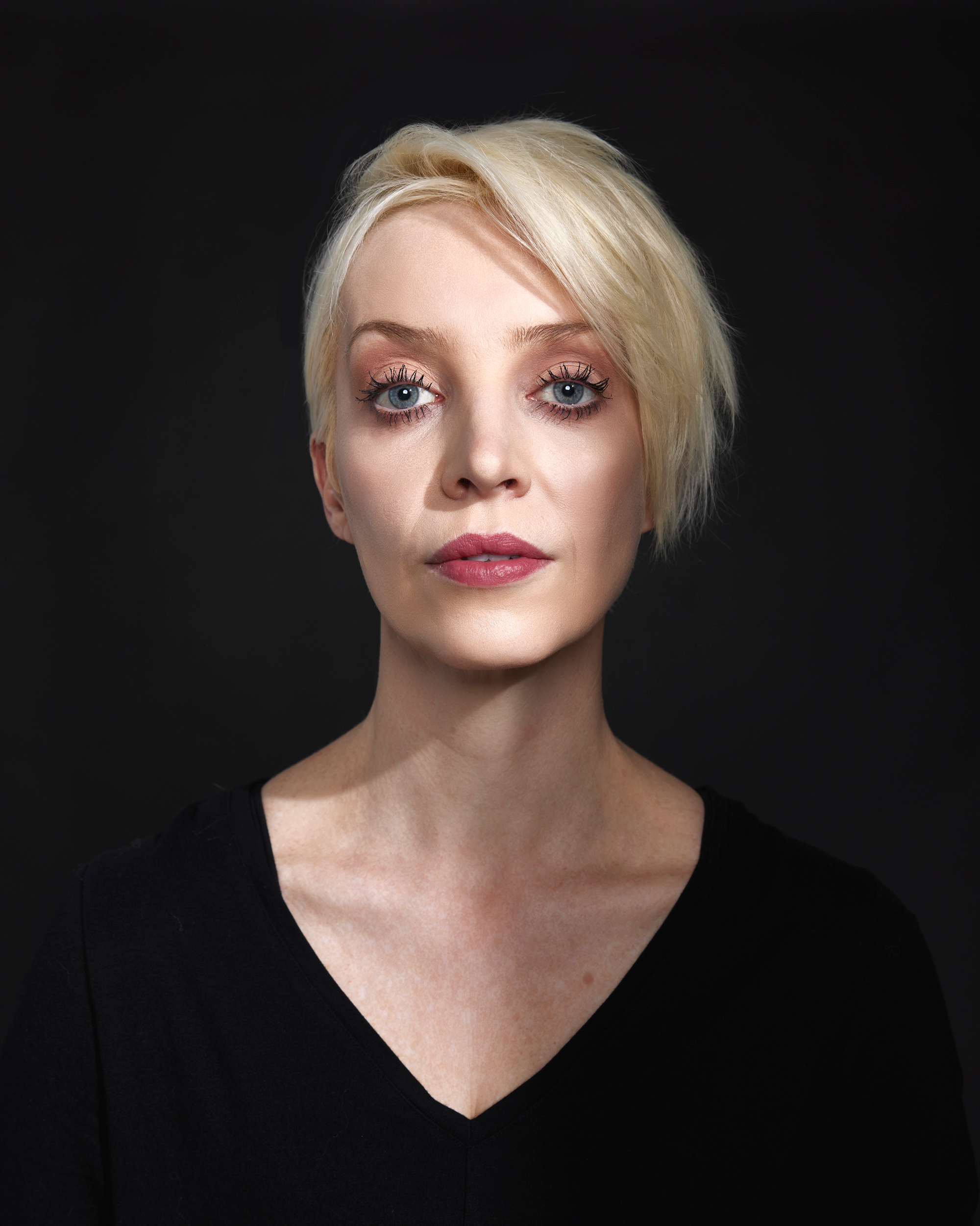 woman poses for a portrait on black 