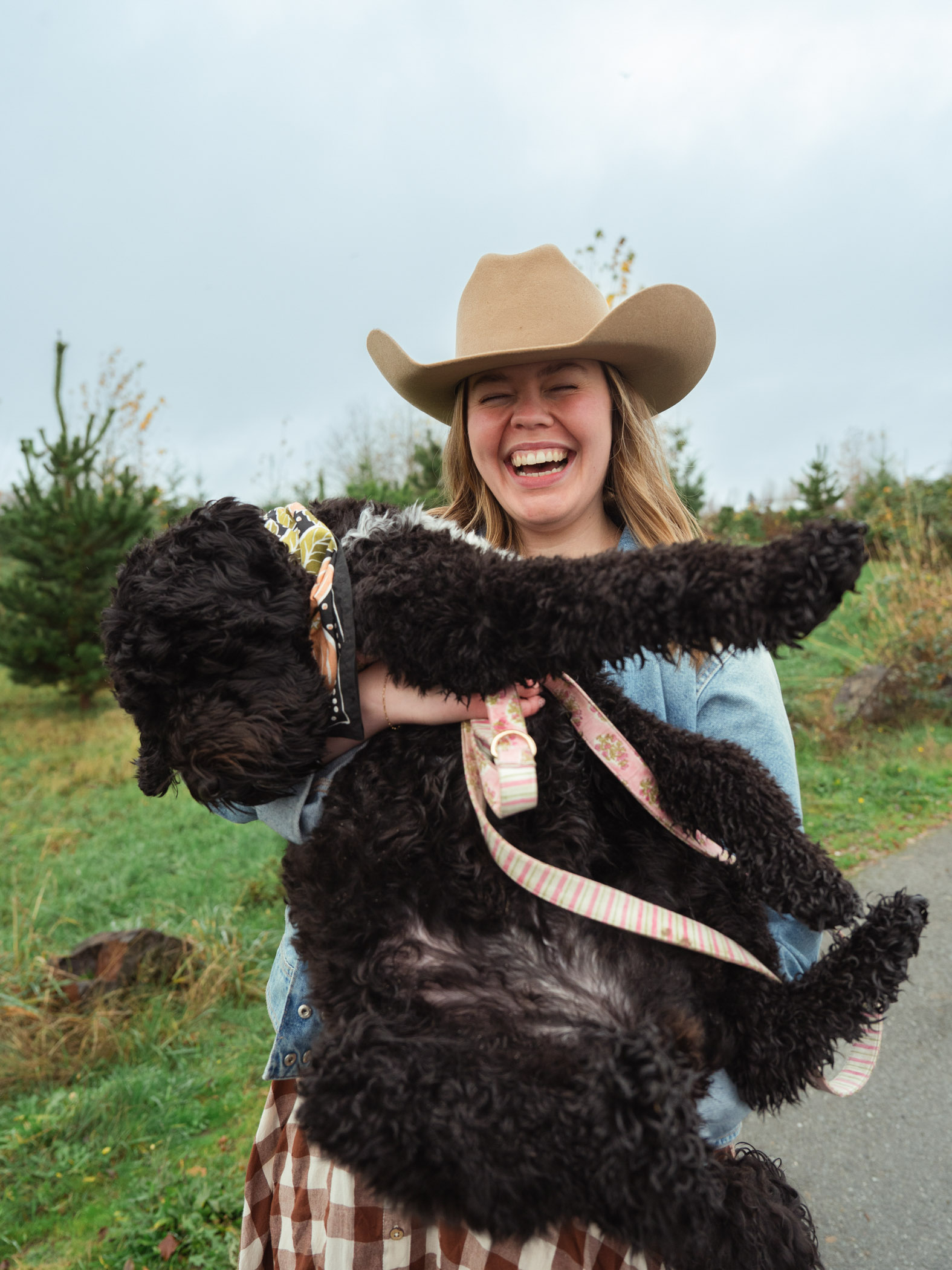 woman holds her giant poodle 