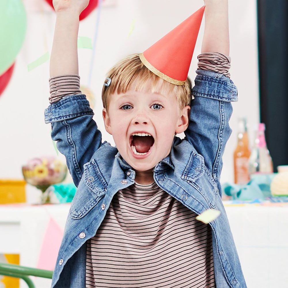 little boy in red party had celebrates while throwing confetti - photo retouch artist jon birdseye little boy with red birthday hat at a birthday party