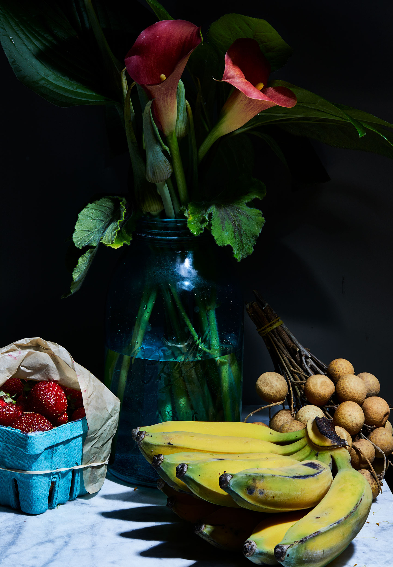 Lillies and fruit on tabletop