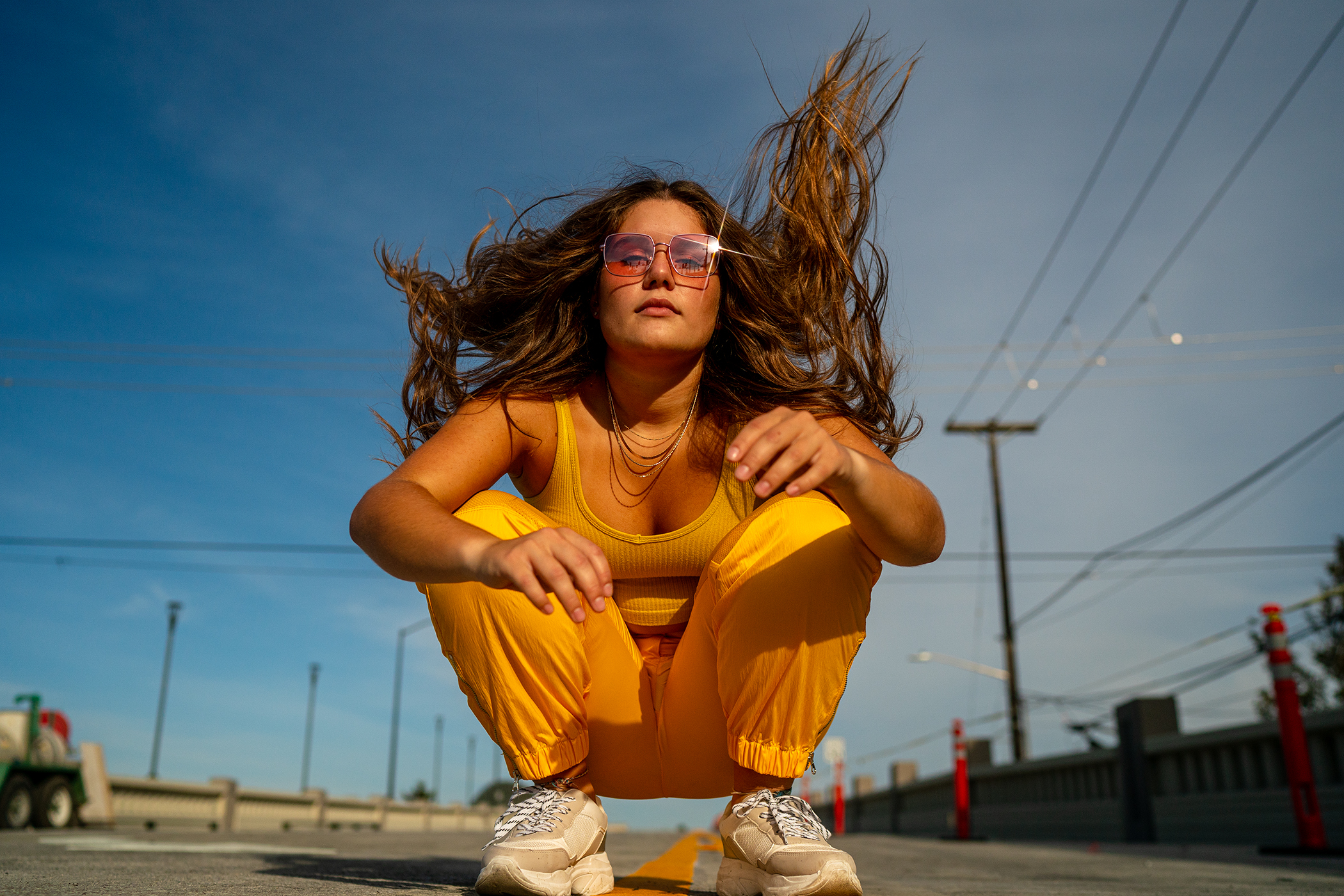 Motion shot, mid dance move, hair blowing in the wind  Crouching down