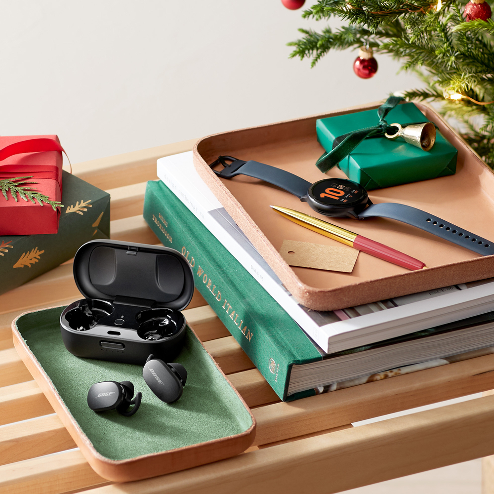 Excited about the new gifts, Old world Italian cookbook, small red glass ball ornaments, bell and ribbon on a gift box, gift wrapping ideas. Red and green color scheme